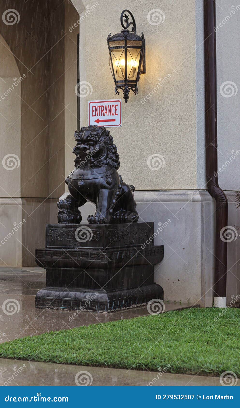 Lion Dog Statue at Entry of Temple during Rain Storm Stock Image