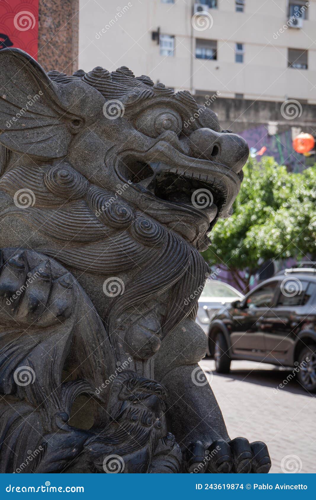 lion. it guards the entrance arch to chinatown and a sphere, inside its mouth, izing wisdom