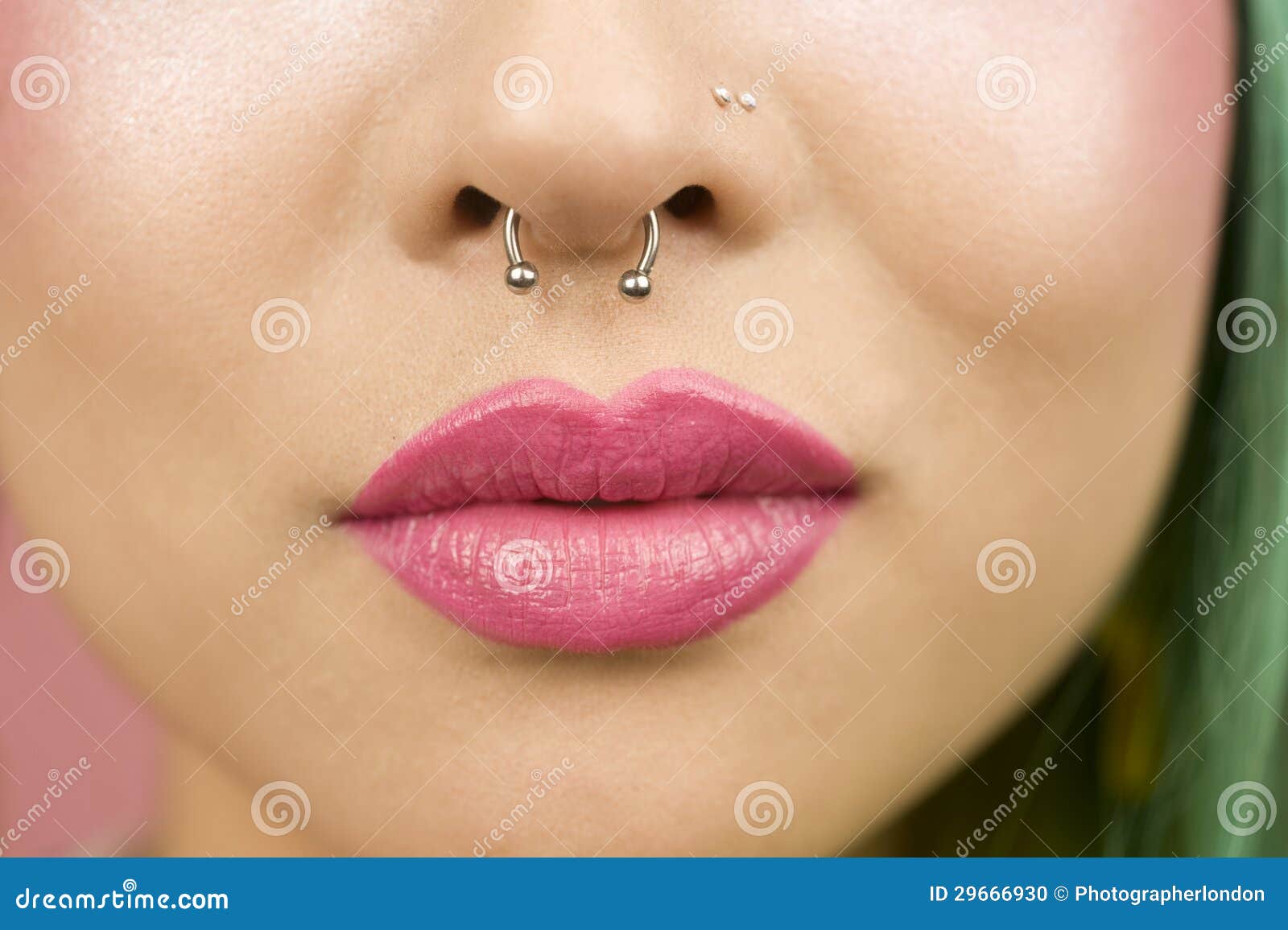 lips of young woman wearing pink lipstick