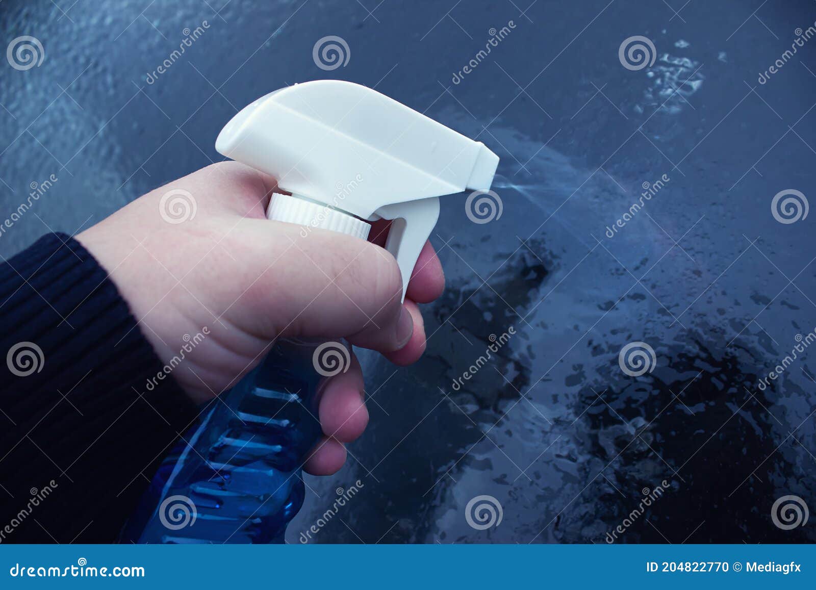 Liquid Spray for Car Window Defrost in Winter Season. Stock Photo