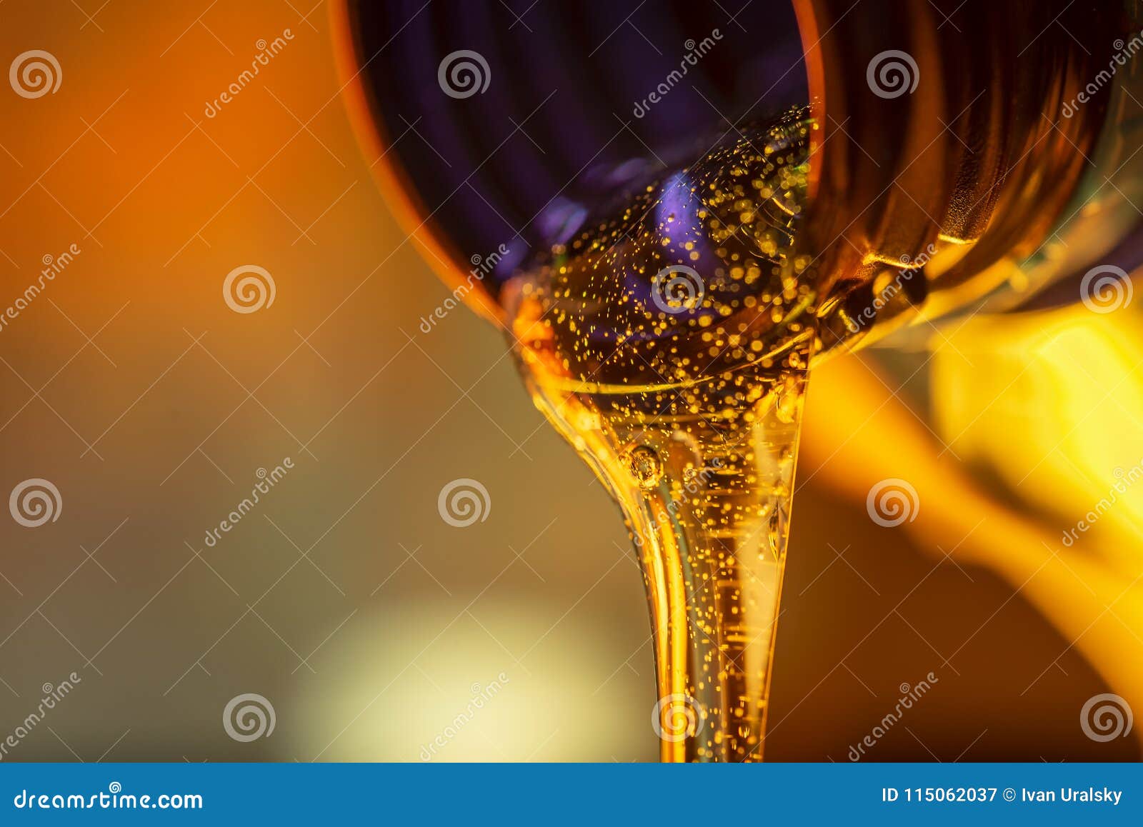liquid stream of motorcycle motor oil flows from the neck of the bottle close-up.