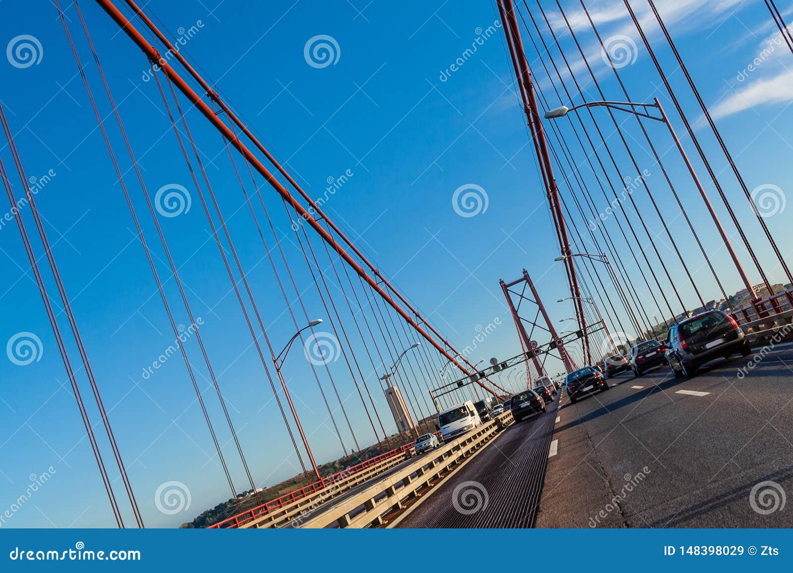 lisbon, portugal. cars crossing or driving through the 25 de abril suspension bridge