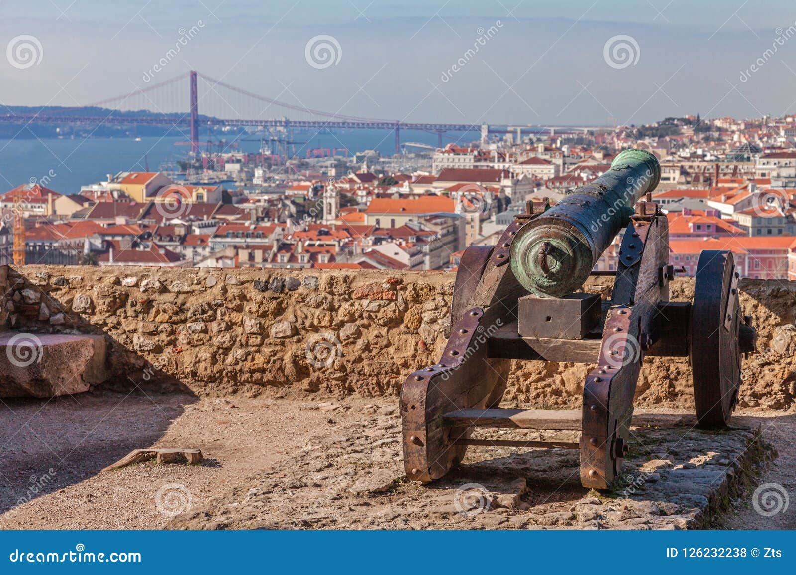 lisbon, portugal. old bronze cannon in sao jorge aka saint george castle and a view of lisbon baixa distric
