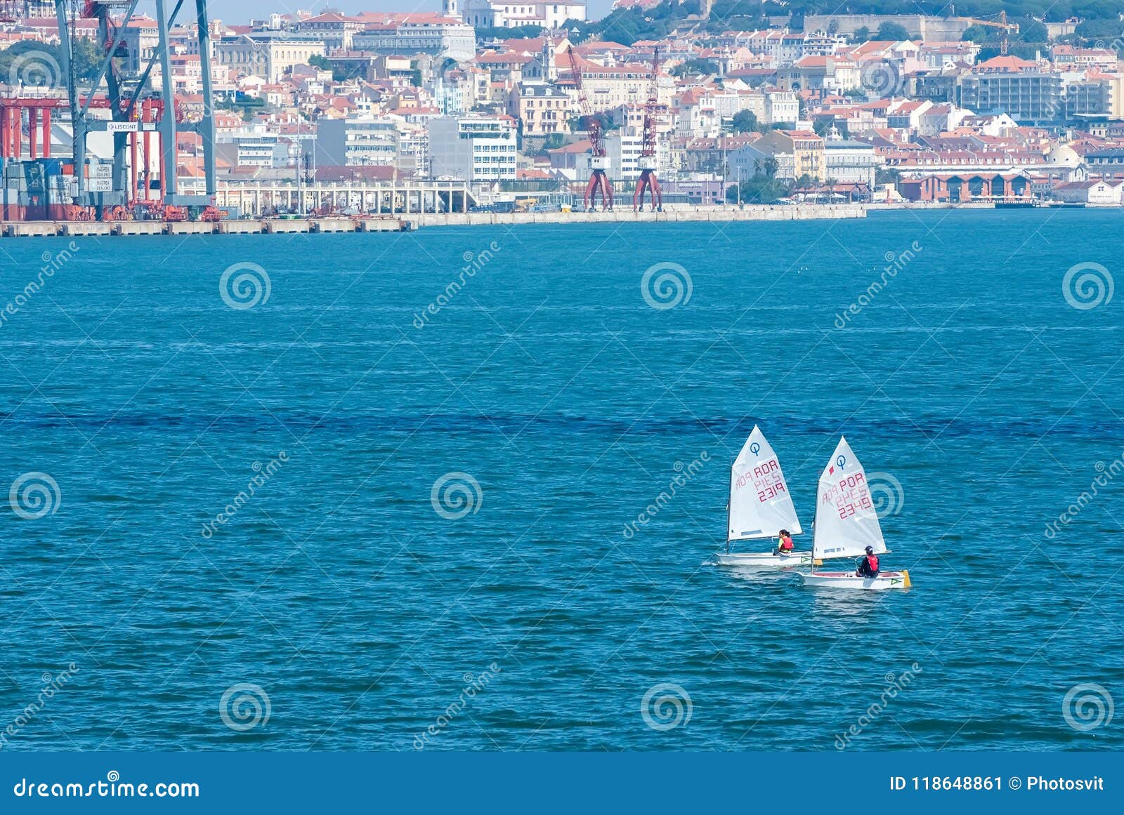 Lissabon Portugal - April 03, 2010: segelbåtar i det blåa havet på cityscape Yachtlopp på solig dag Havsseglingmästerskap Regatta- och yachtseglingsport Resa vid vatten med affärsföretag