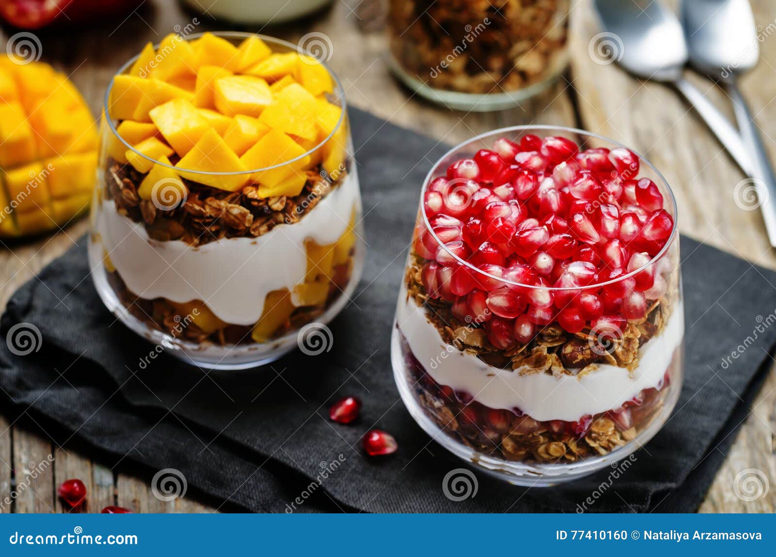 List of Greek Yogurt Granola Parfait. Pomegranate and Mango Stock Photo