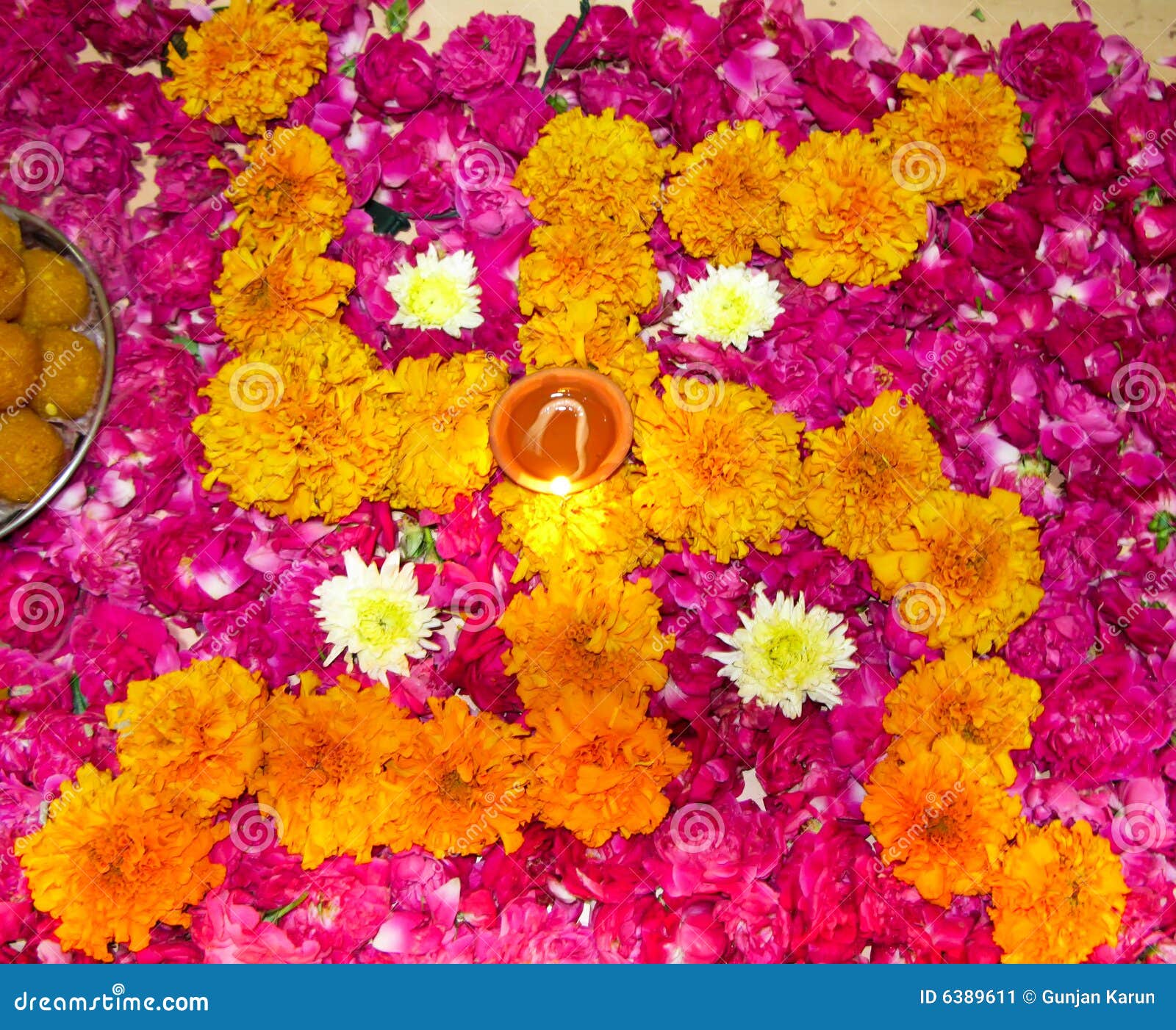 lit diya on a floral hindu pattern