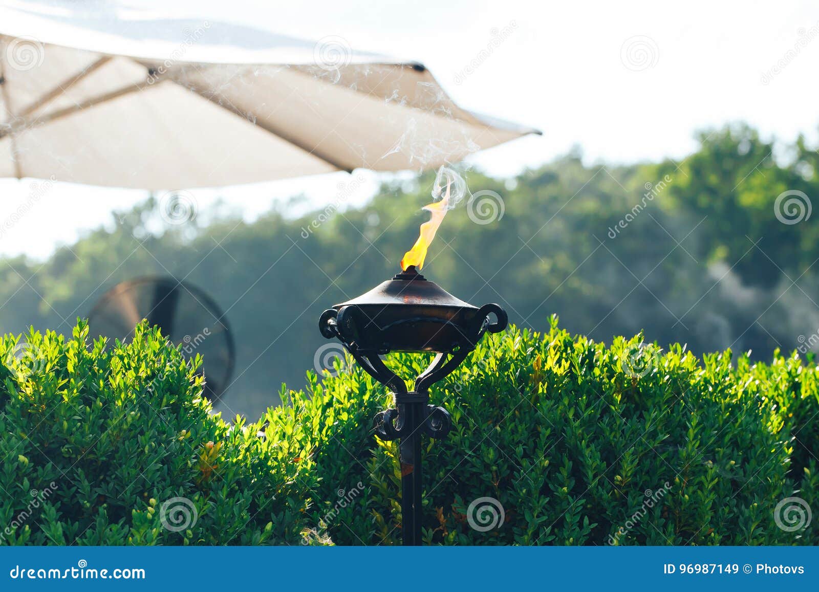 Lit Torch with Orange Flame in Garden Used As Mosquito Repellent Stock