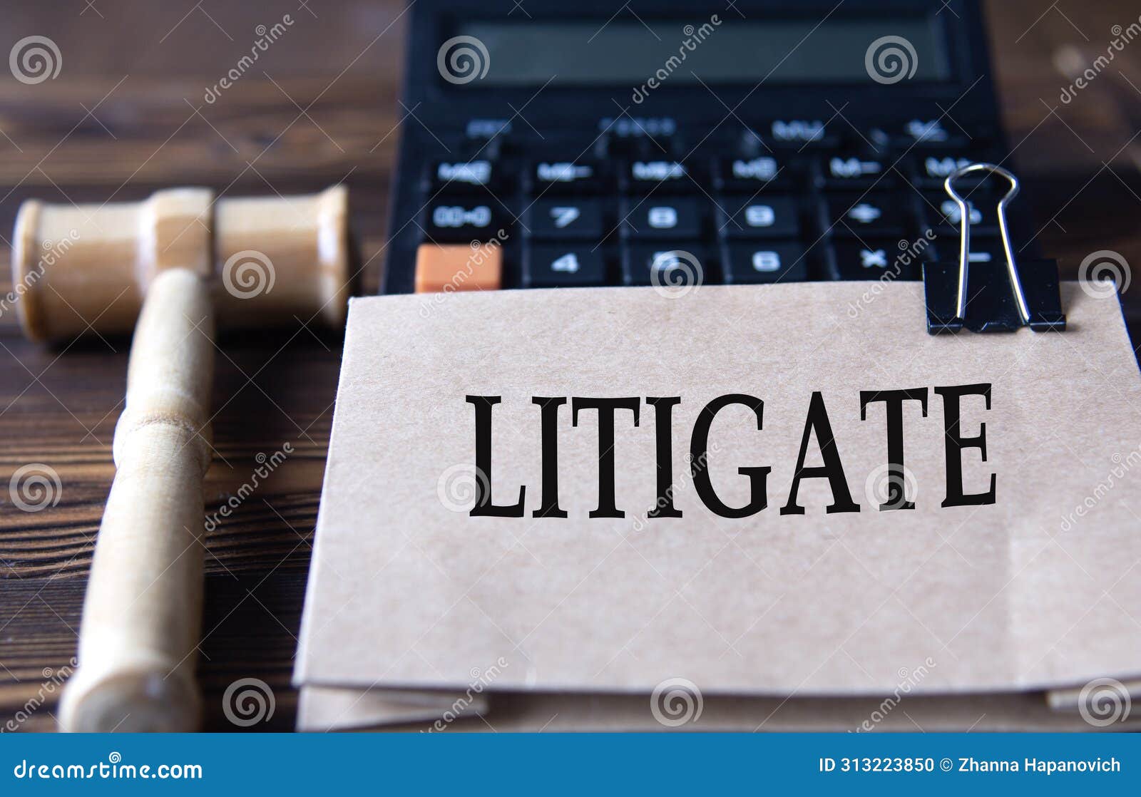 litigate - word on light brown paper against the background of a calculator and a judge's gavel