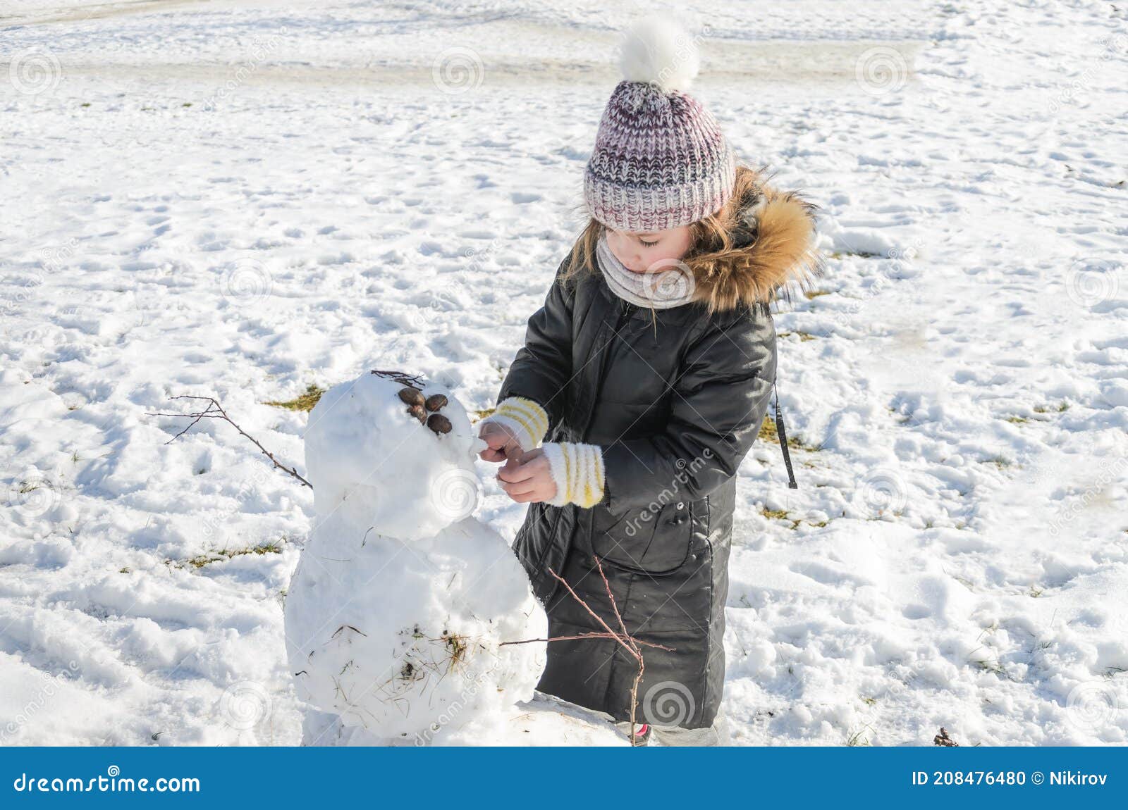 Little Adorable Girl Child Sculpts Snowman from Snow in Winter Stock ...