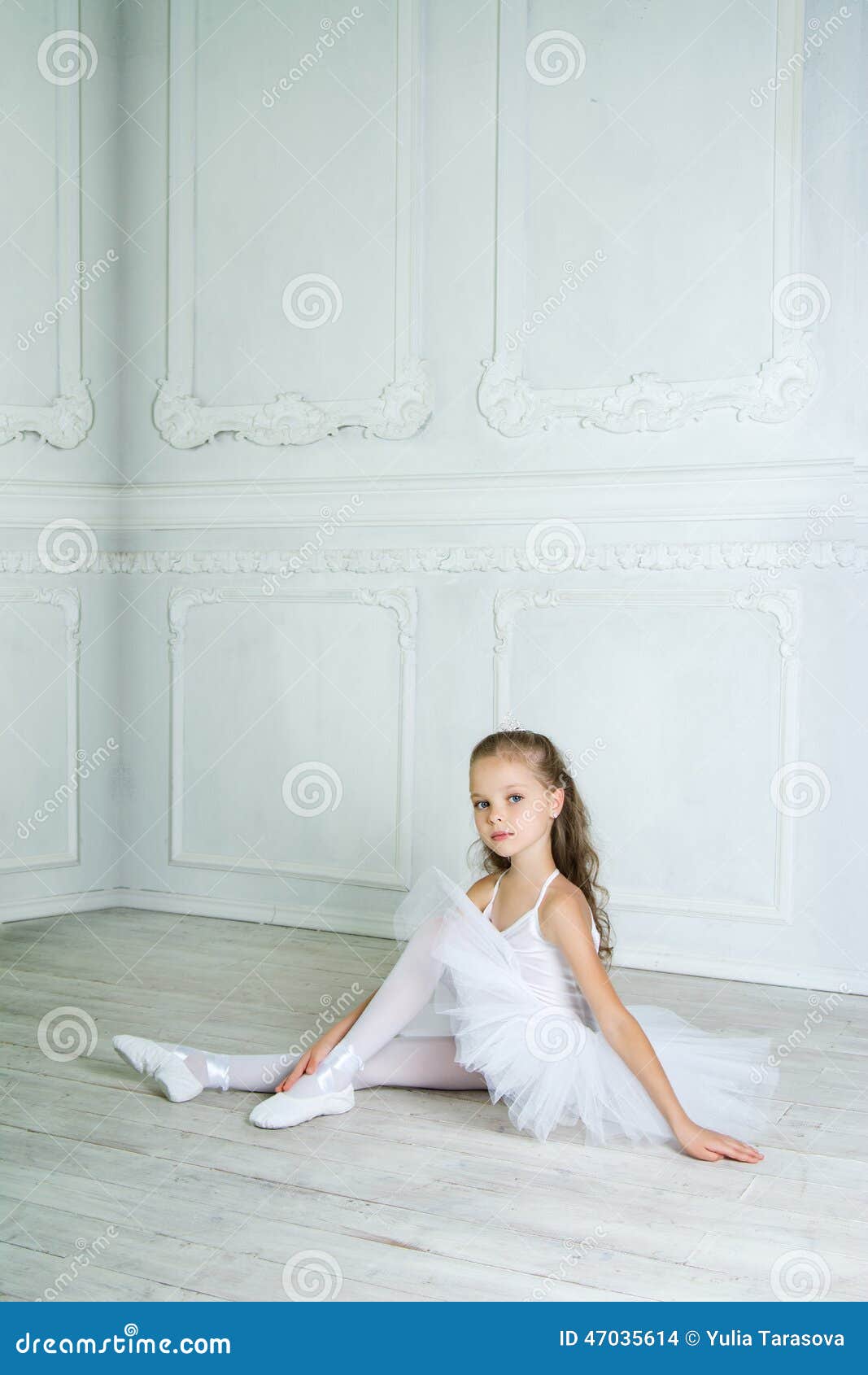 a little adorable young ballerina in a playful mood in the inter