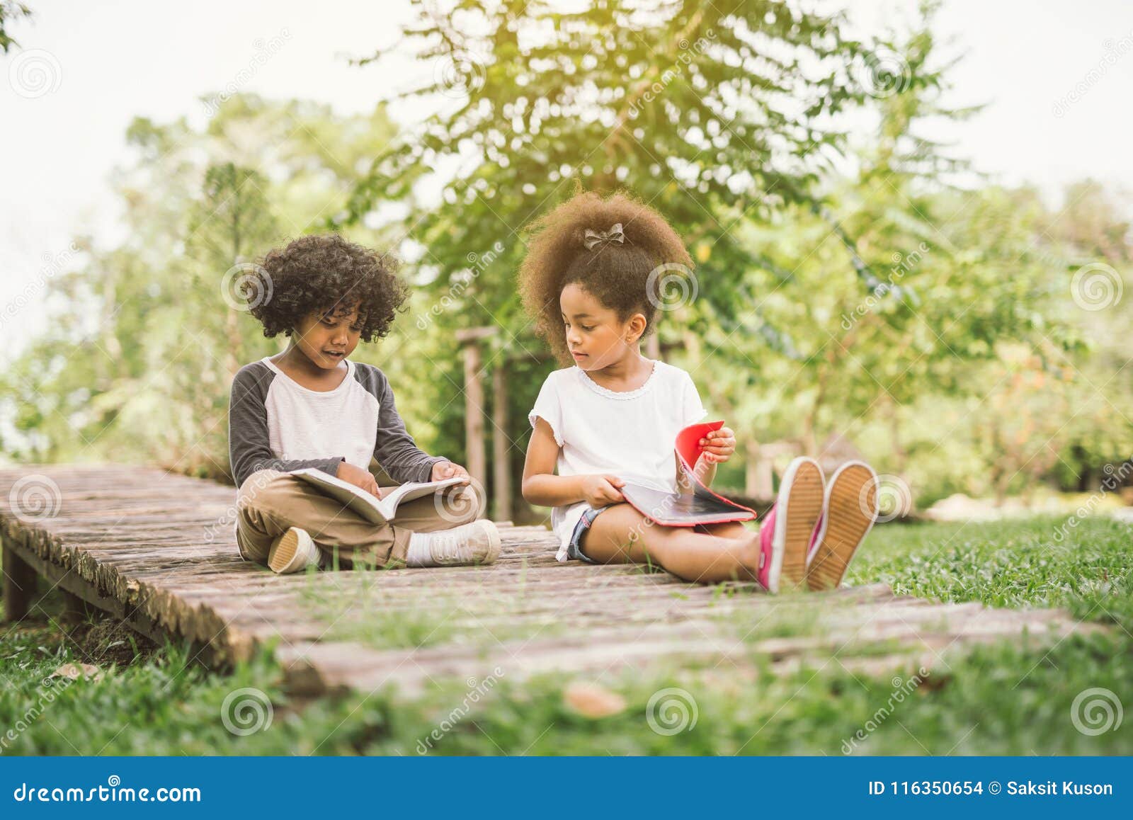 little child reading with friend