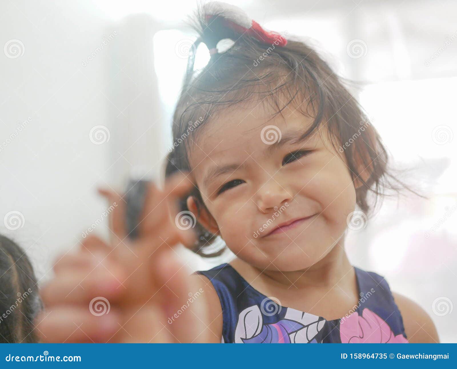 Little Asian Baby Girl Is Being Interested In Finger Dolls Playing By