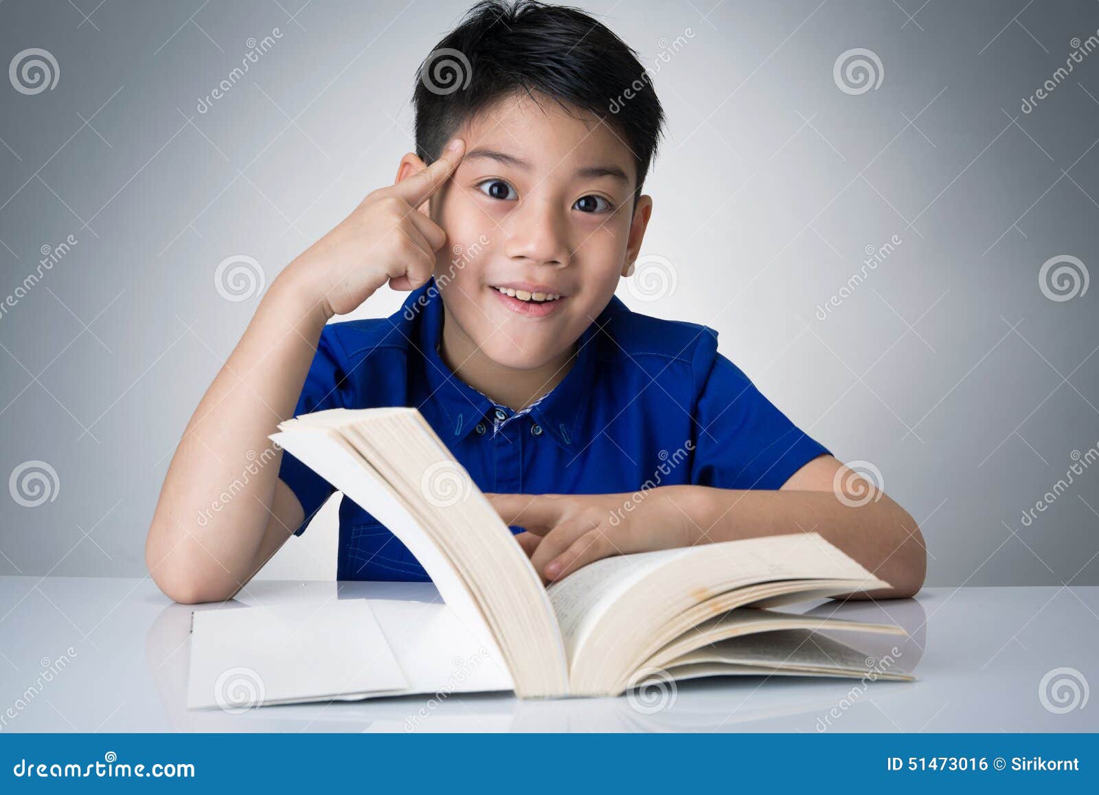 Little Asian Boy Read A Book And Think About Stock Photo ...