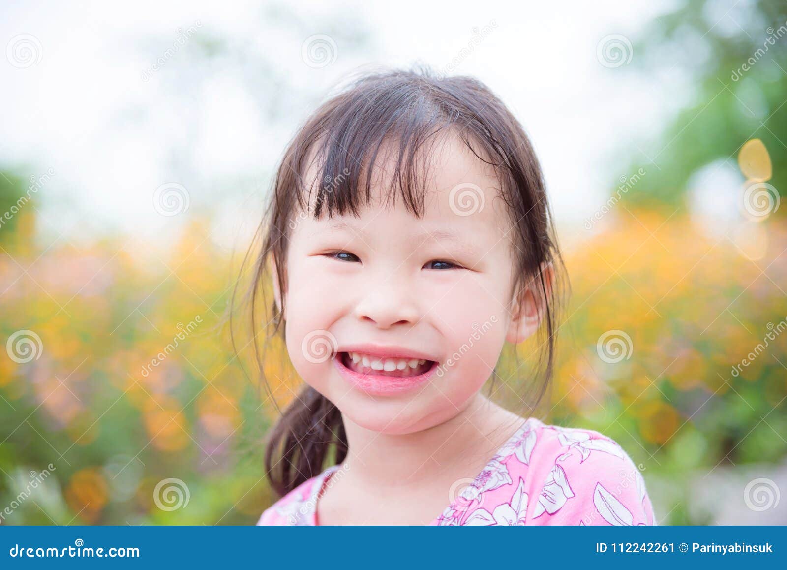 Little Asian Girl Smiling at Camera in Flower Garden Stock Image ...