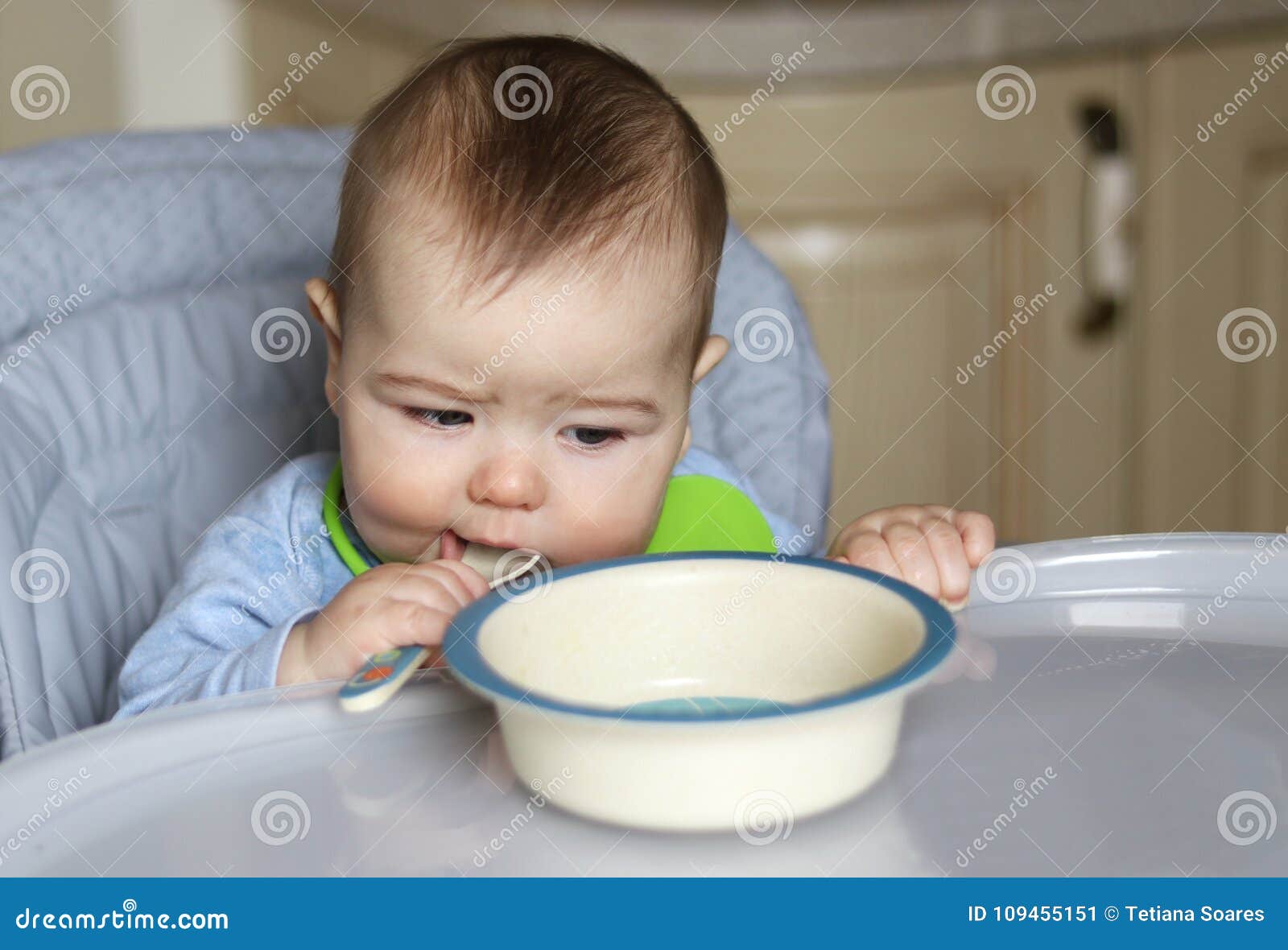little baby boy eating in his feeding chair stock image image of