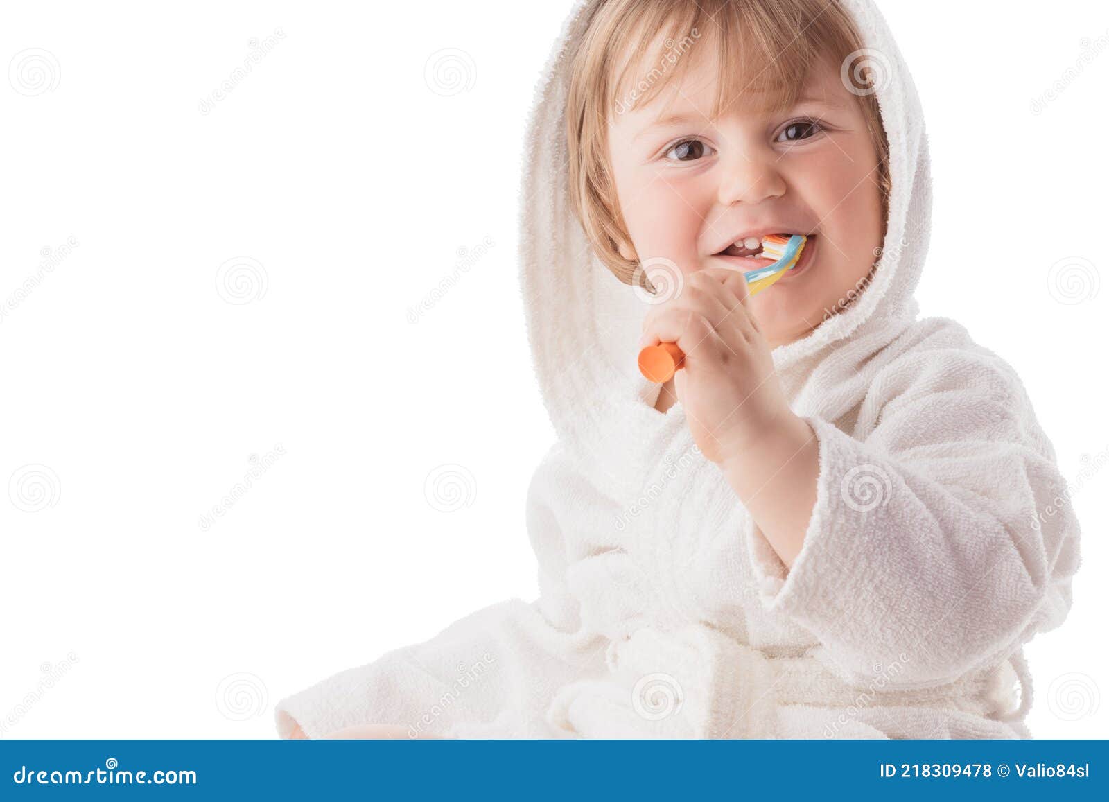 Little Baby Brushing His Teeth Under a White Towel Stock Photo Image