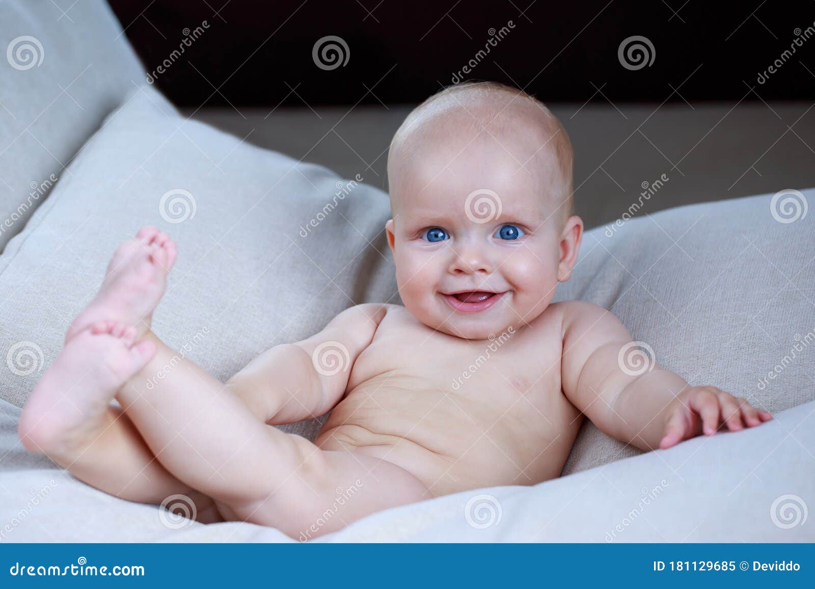 Little baby on the couch stock image. Image of bedding 181129685
