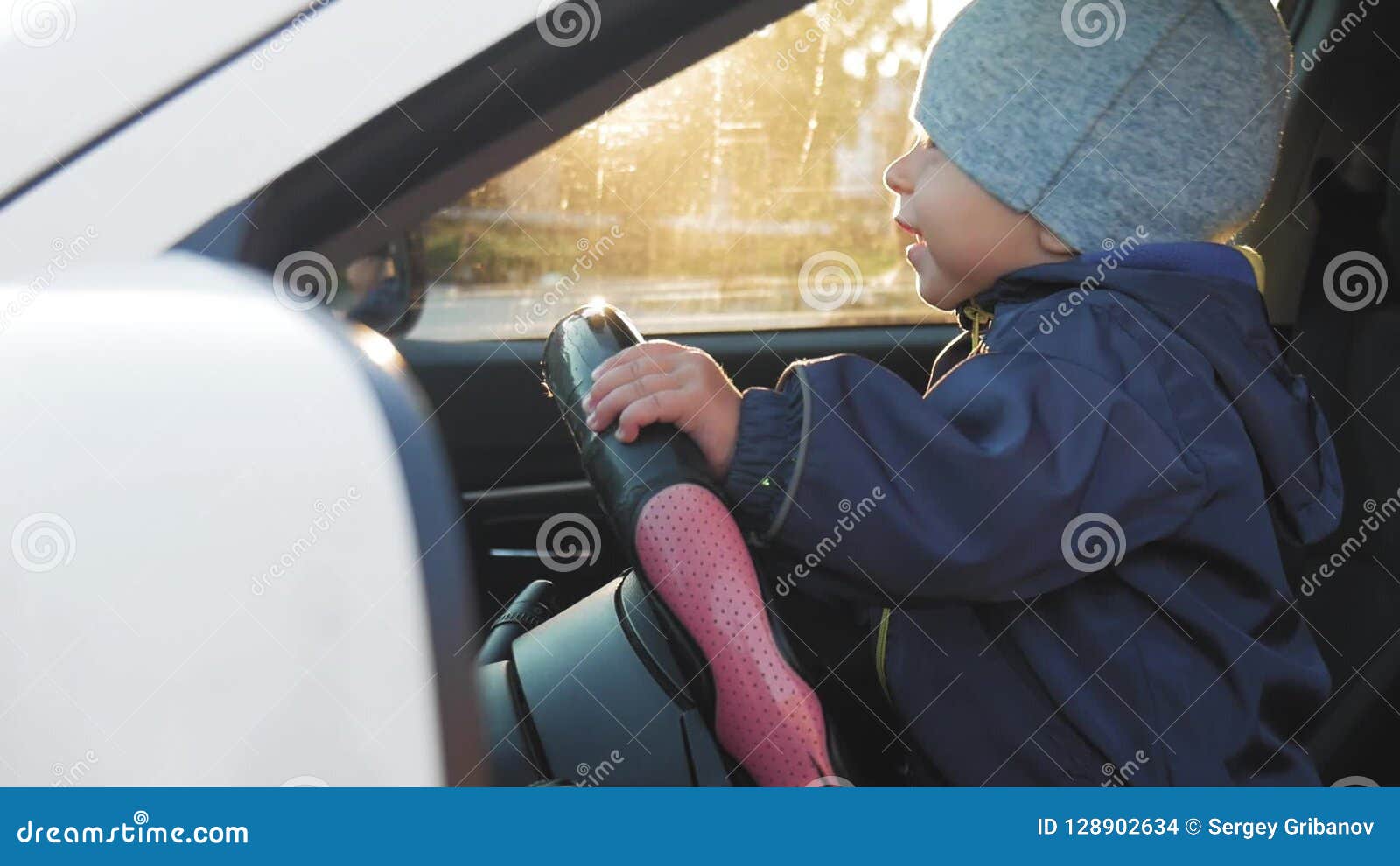 A little baby driving car. stock footage. Video of cute 128902634