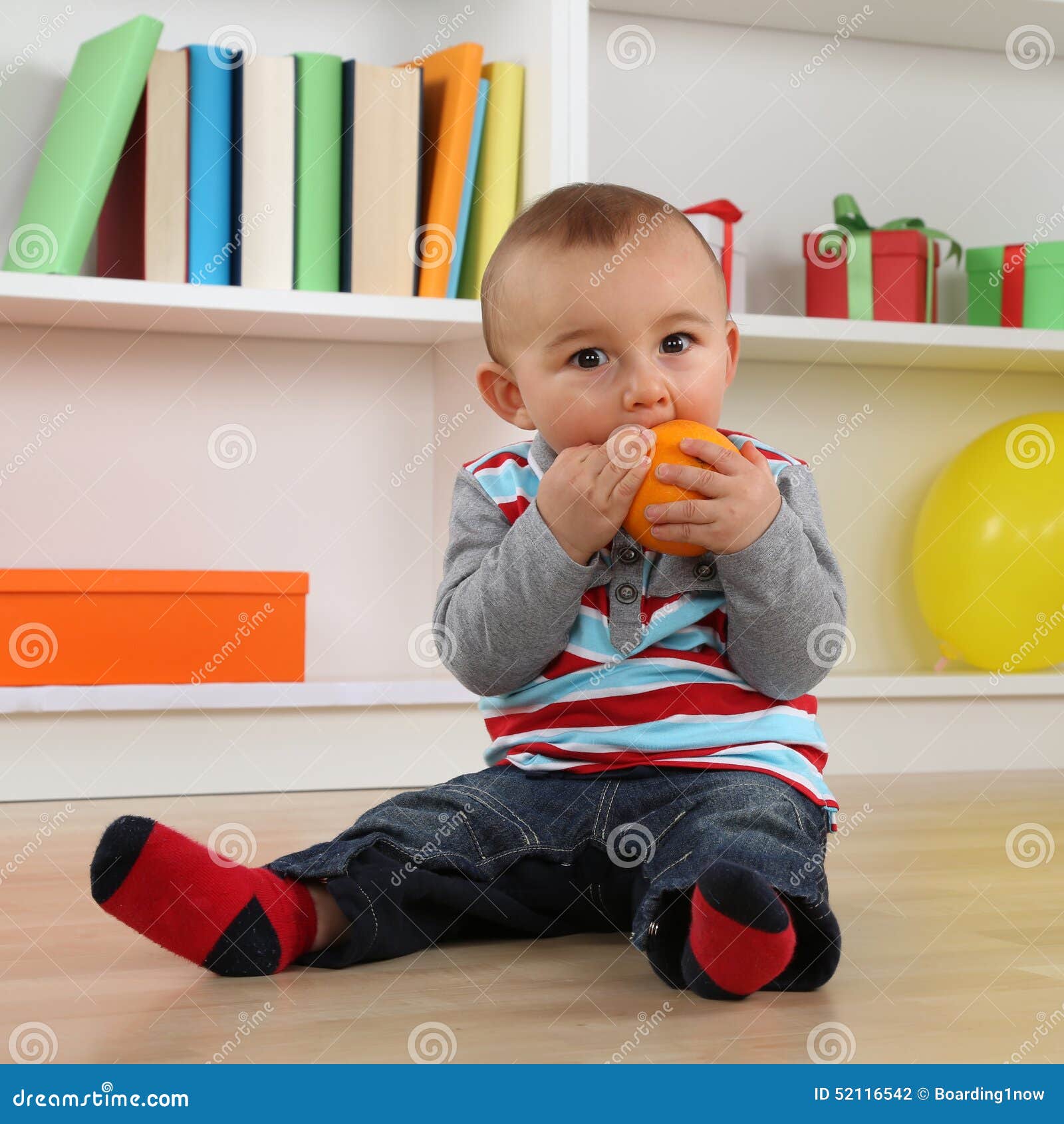 Little Baby Eating Orange Fruit Stock Photo - Image of babies, kids