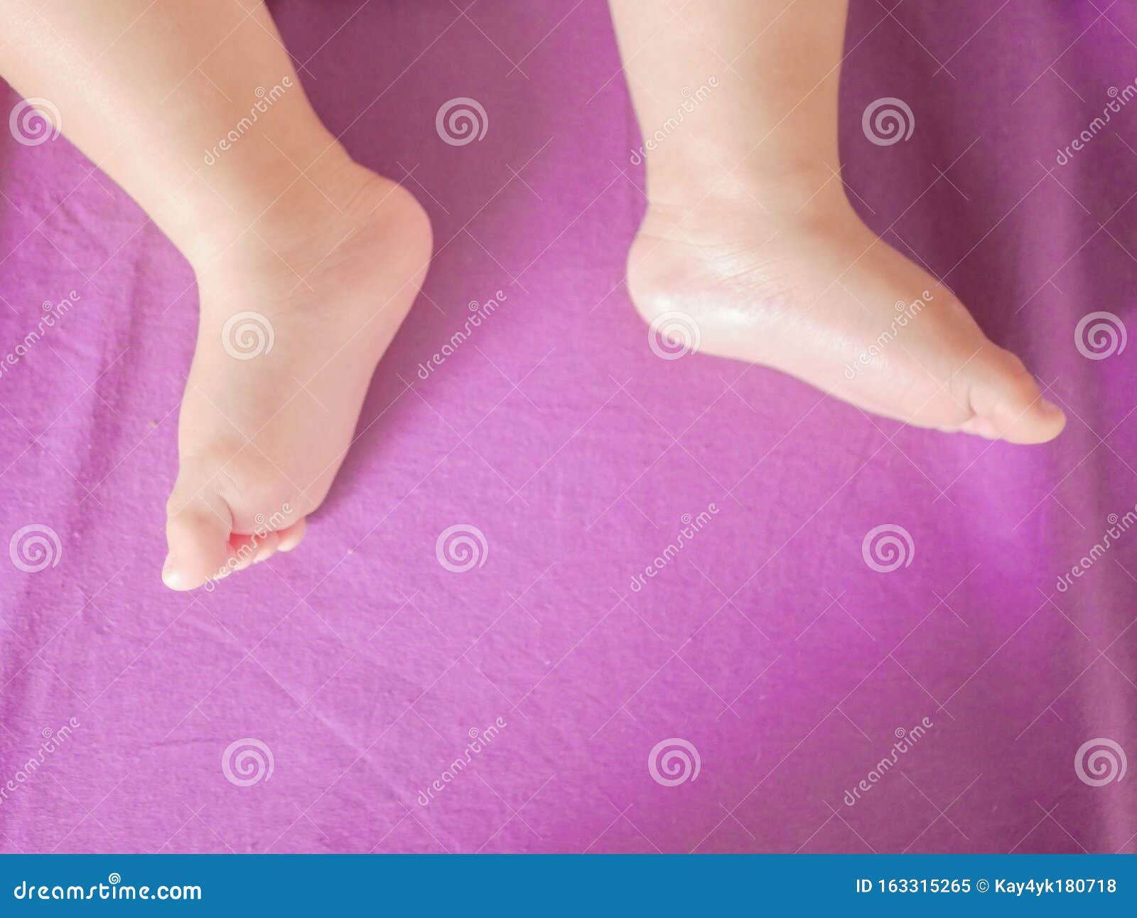 little baby feet. theres nothing quite so sweet as tiny little baby feet. little baby boy on bed. close up. space for copy