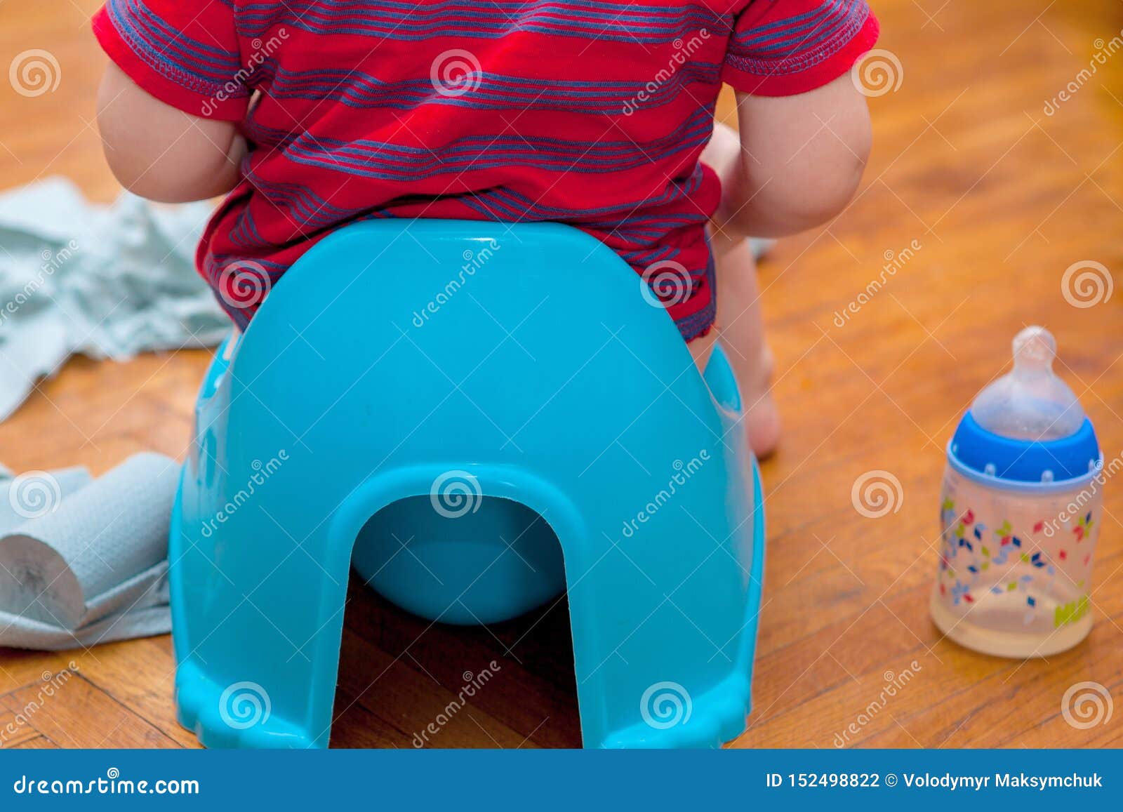 Little Baby Sitting on Chamber Pot with Toilet Paper and Pacifier on a ...