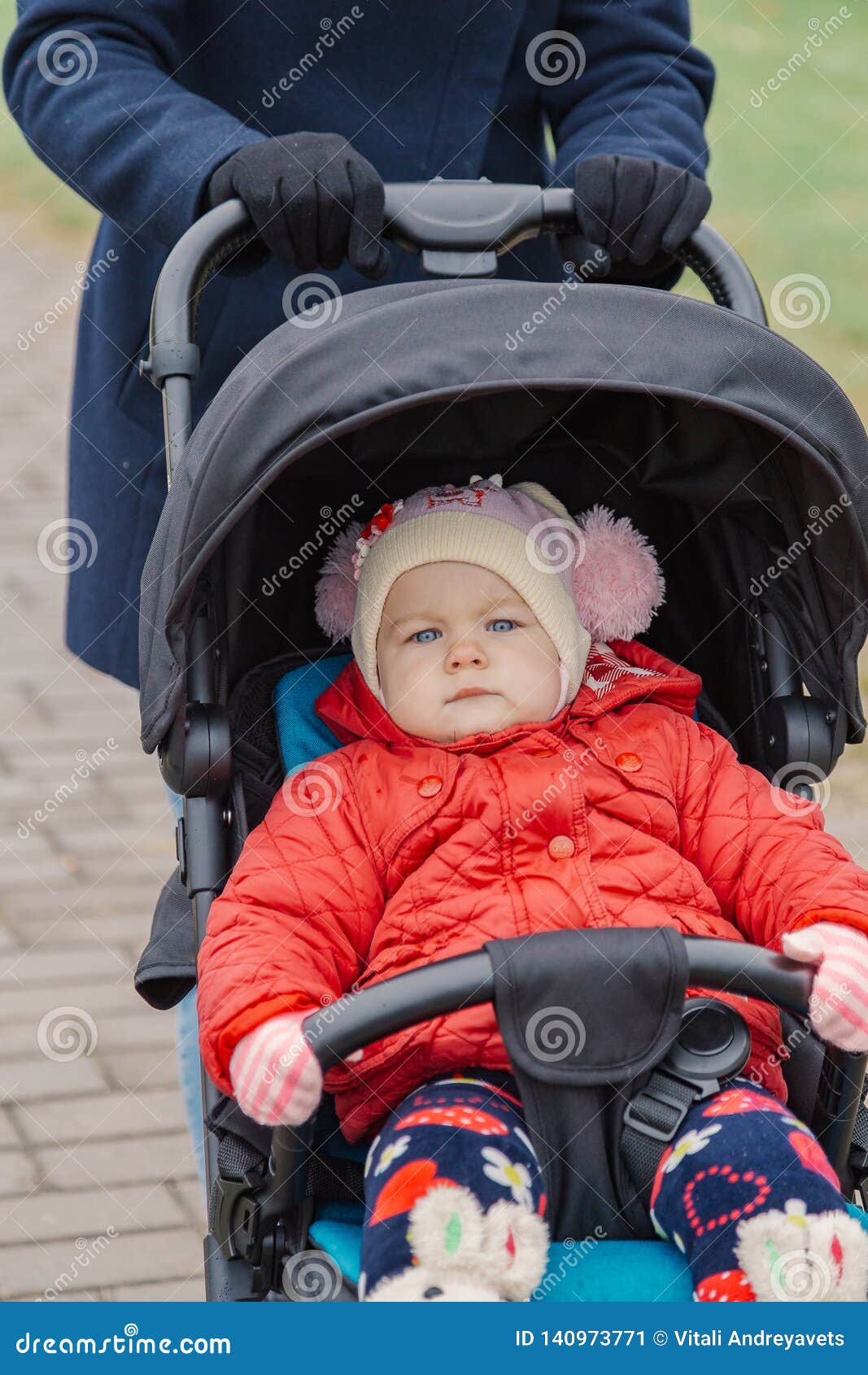 The Little Baby is Sitting in the Pram. Stock Image Image of