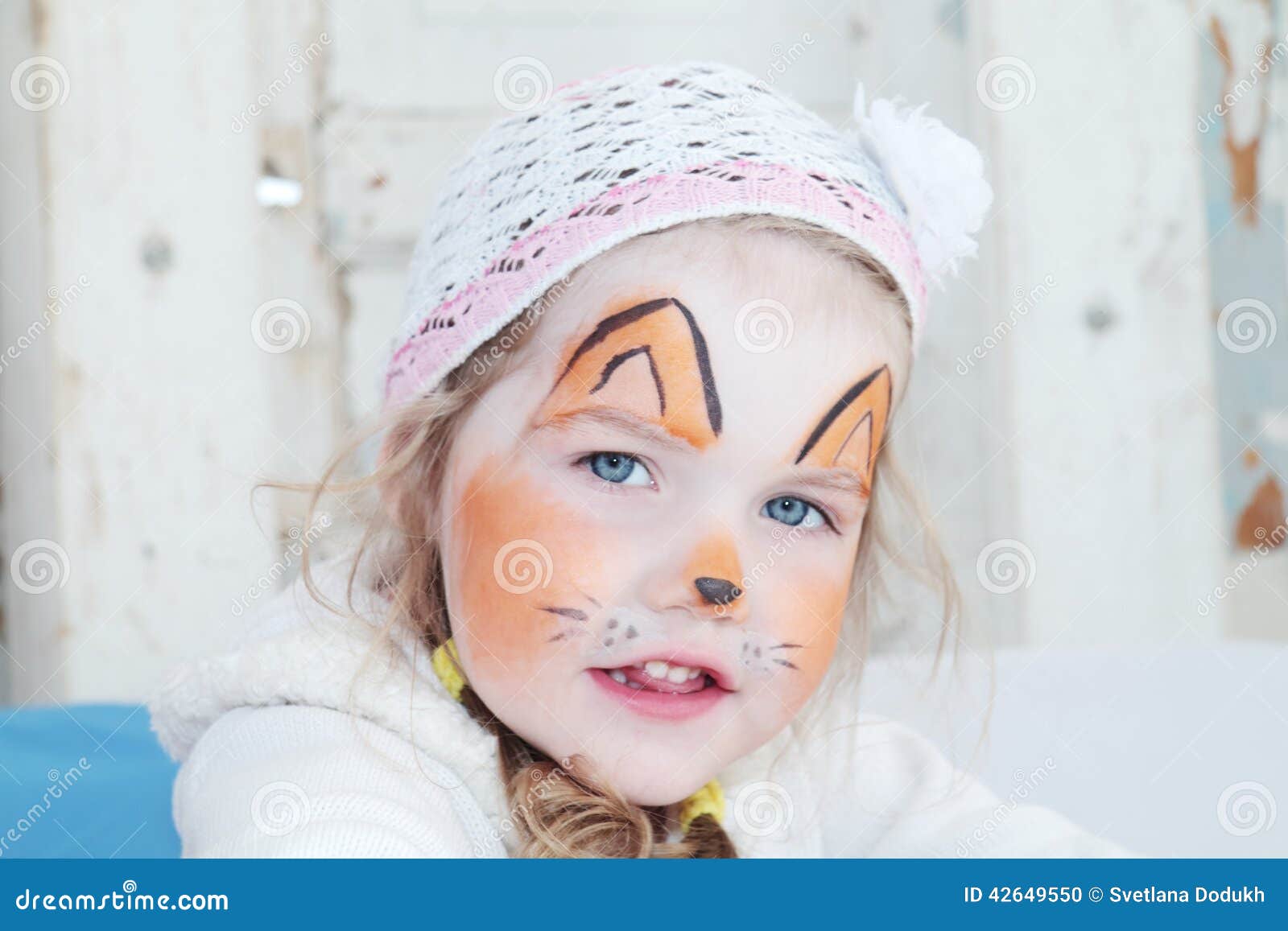A Girl with Orange Face Paint · Free Stock Photo