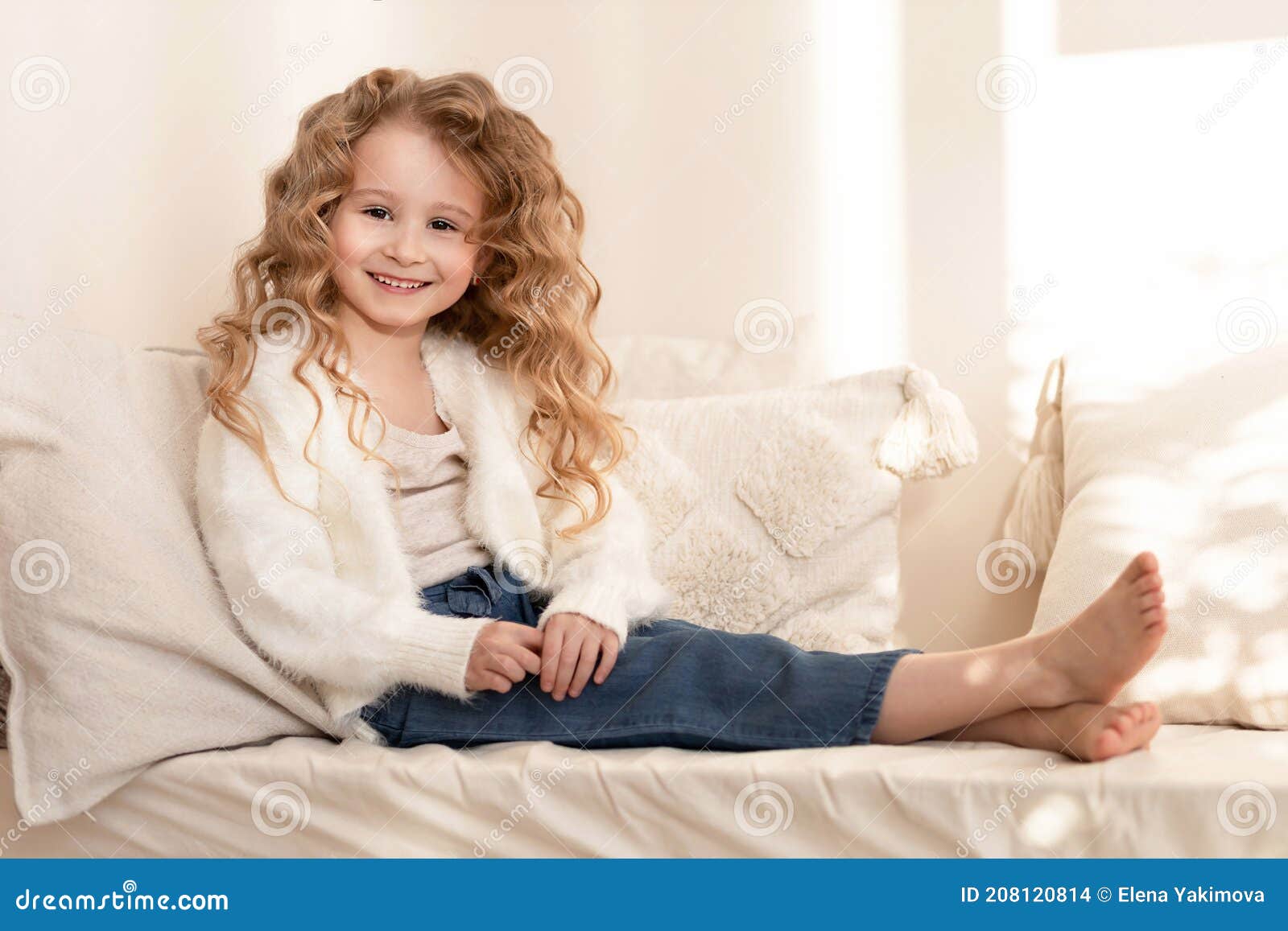 Little Beautiful Happy Girl Sitting on the Couch, Bed with Soft Pillows ...