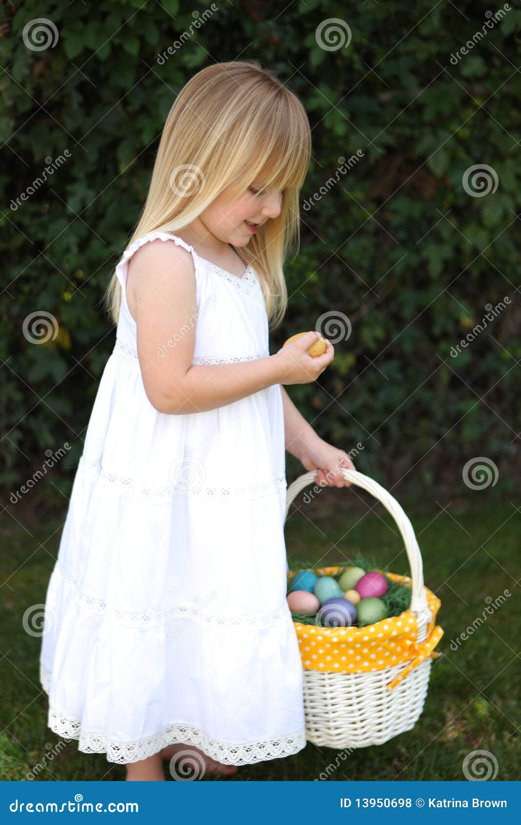 Little Blonde Girl Holding Easter Eggs in a Basket Stock Photo Image