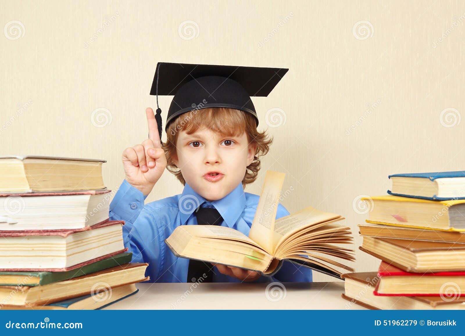 little boy in academic hat quoted old book
