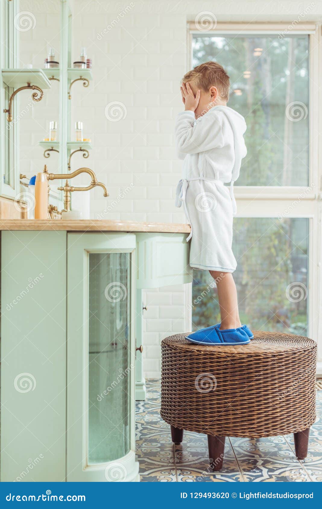 Little boy in bathroom stock photo. Image of slippers 129493620