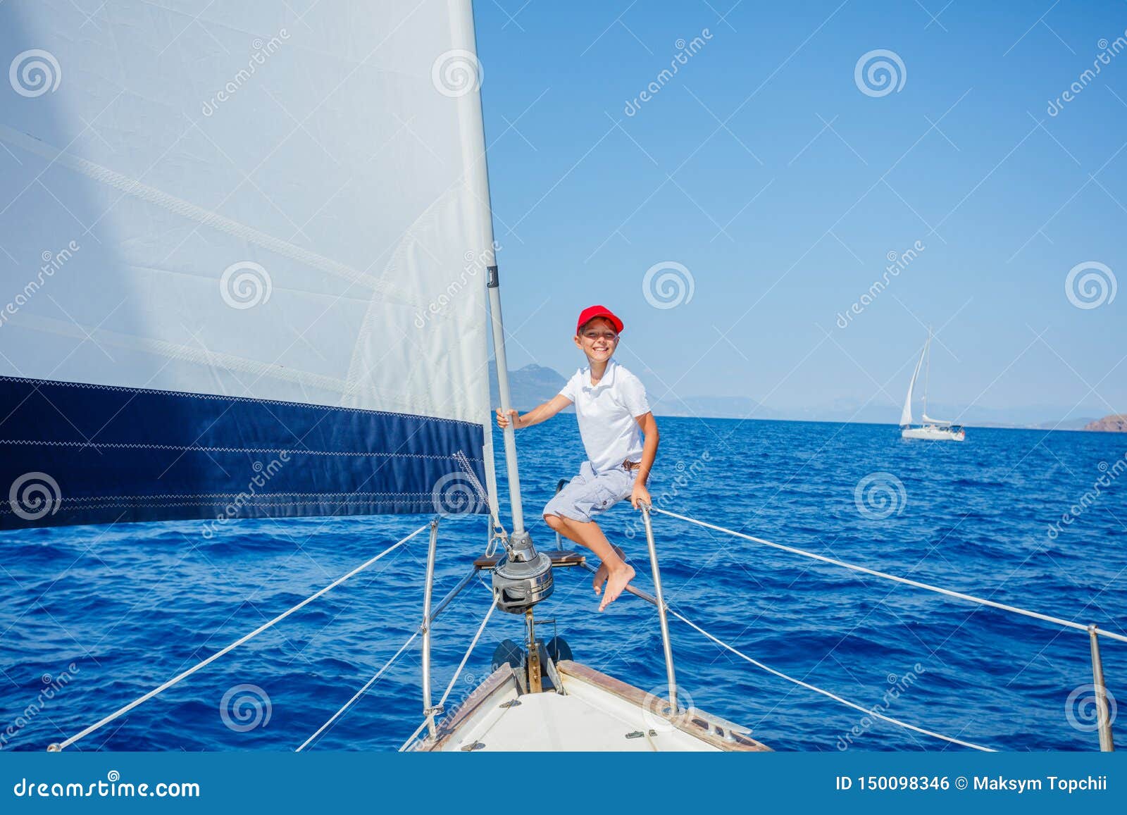little boy on board of sailing yacht on summer cruise. travel adventure, yachting with child on family vacation.
