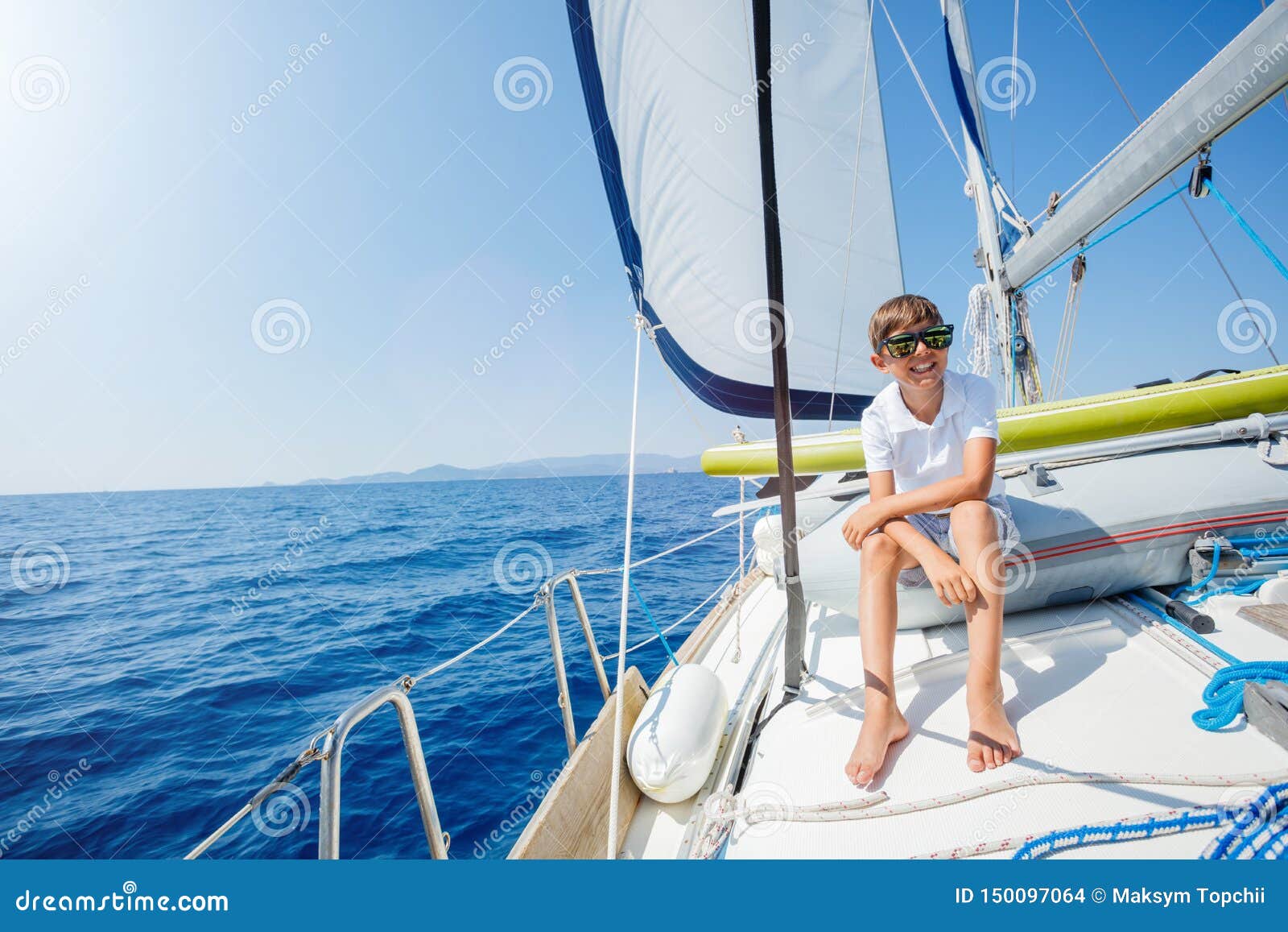 little boy on board of sailing yacht on summer cruise. travel adventure, yachting with child on family vacation.