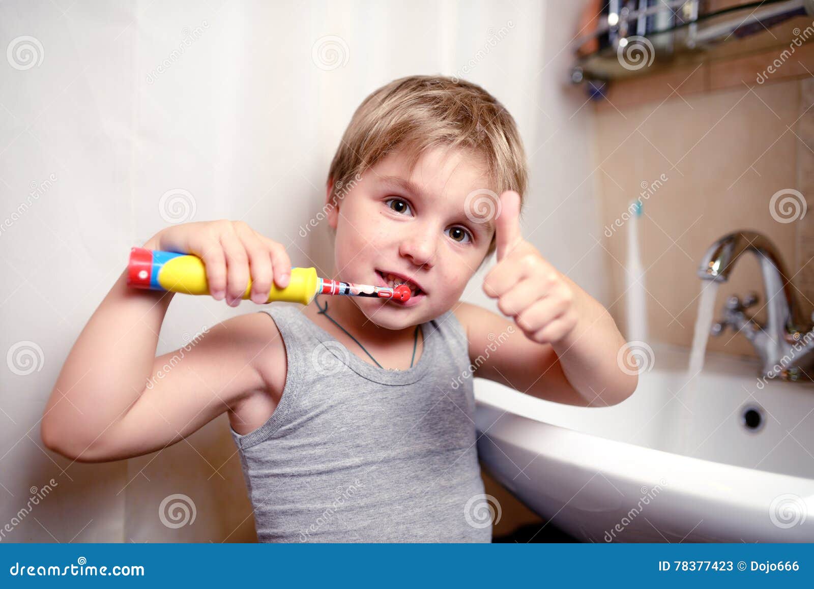 Little Boy Brushing Teeth in Bath with Electric Brush Stock Image