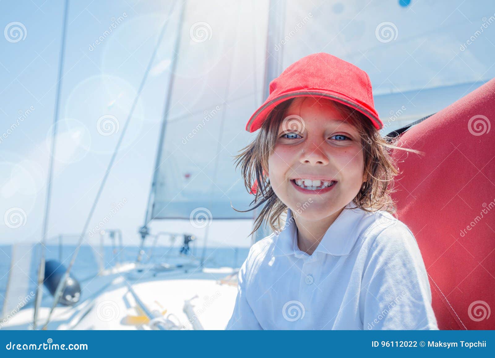 little boy captain on board of sailing yacht on summer cruise. travel adventure, yachting with child on family vacation.