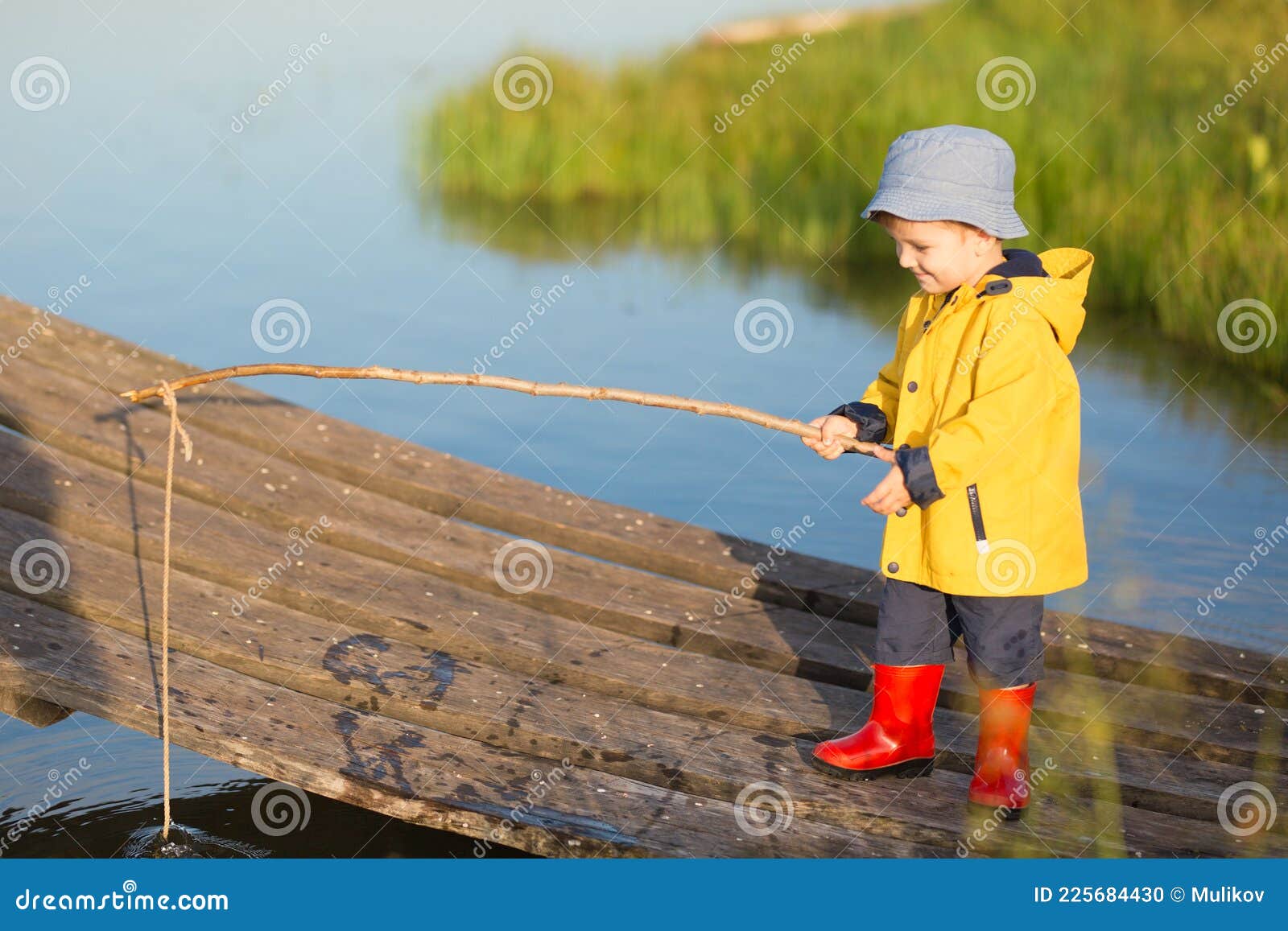 Little Boy Catching a Fish from Wooden Dock Stock Photo Image of