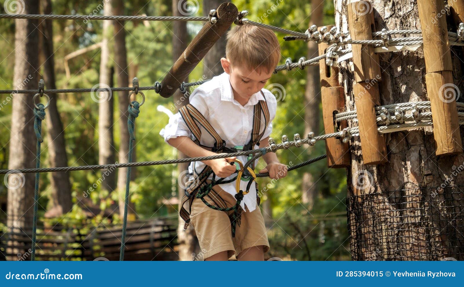 Little Boy Connecting His Safety Rope and Hook before Climbing Up