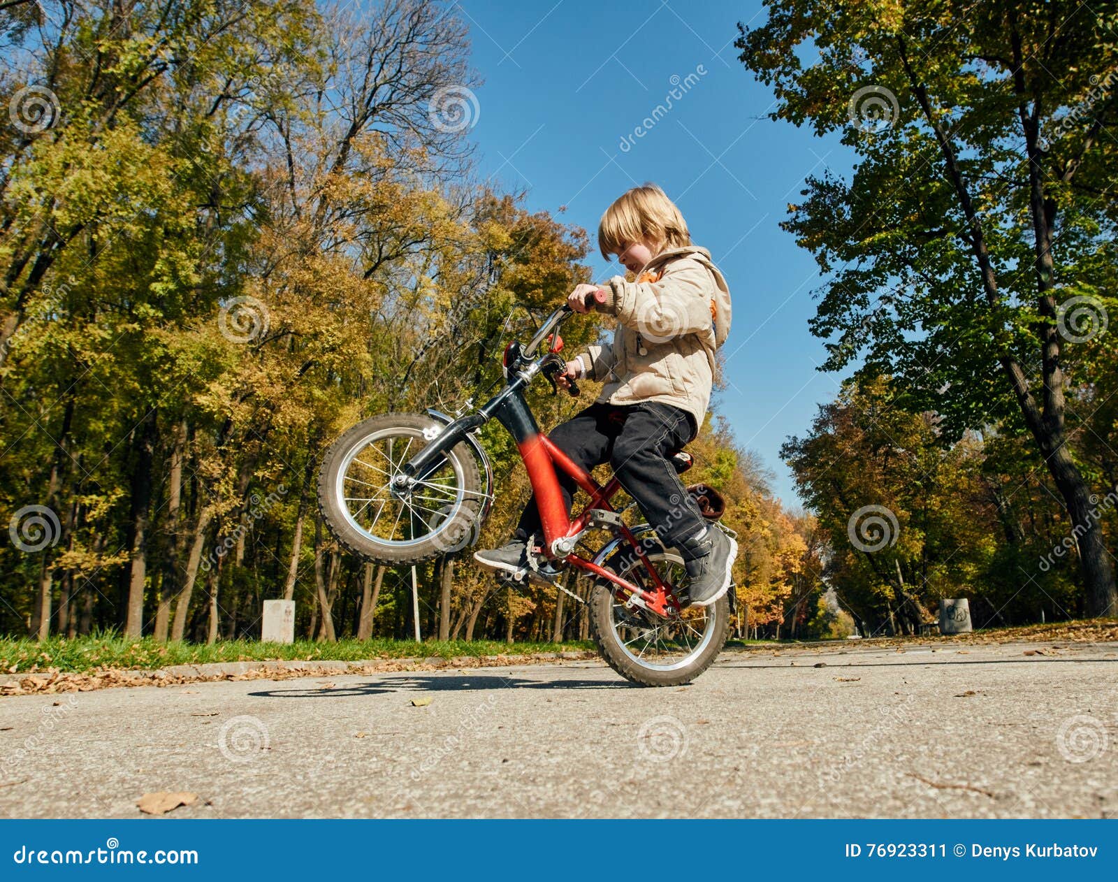 Little boy doing a wheelie stock image. Image of cycle - 76923311