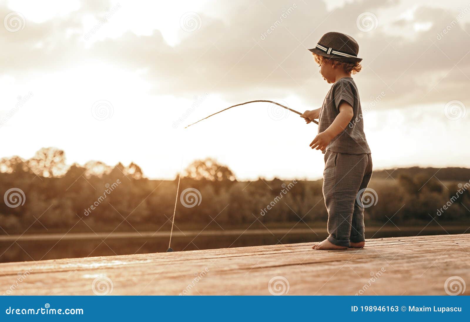 Little Boy with Fishing Rod on River Bank Stock Image - Image of