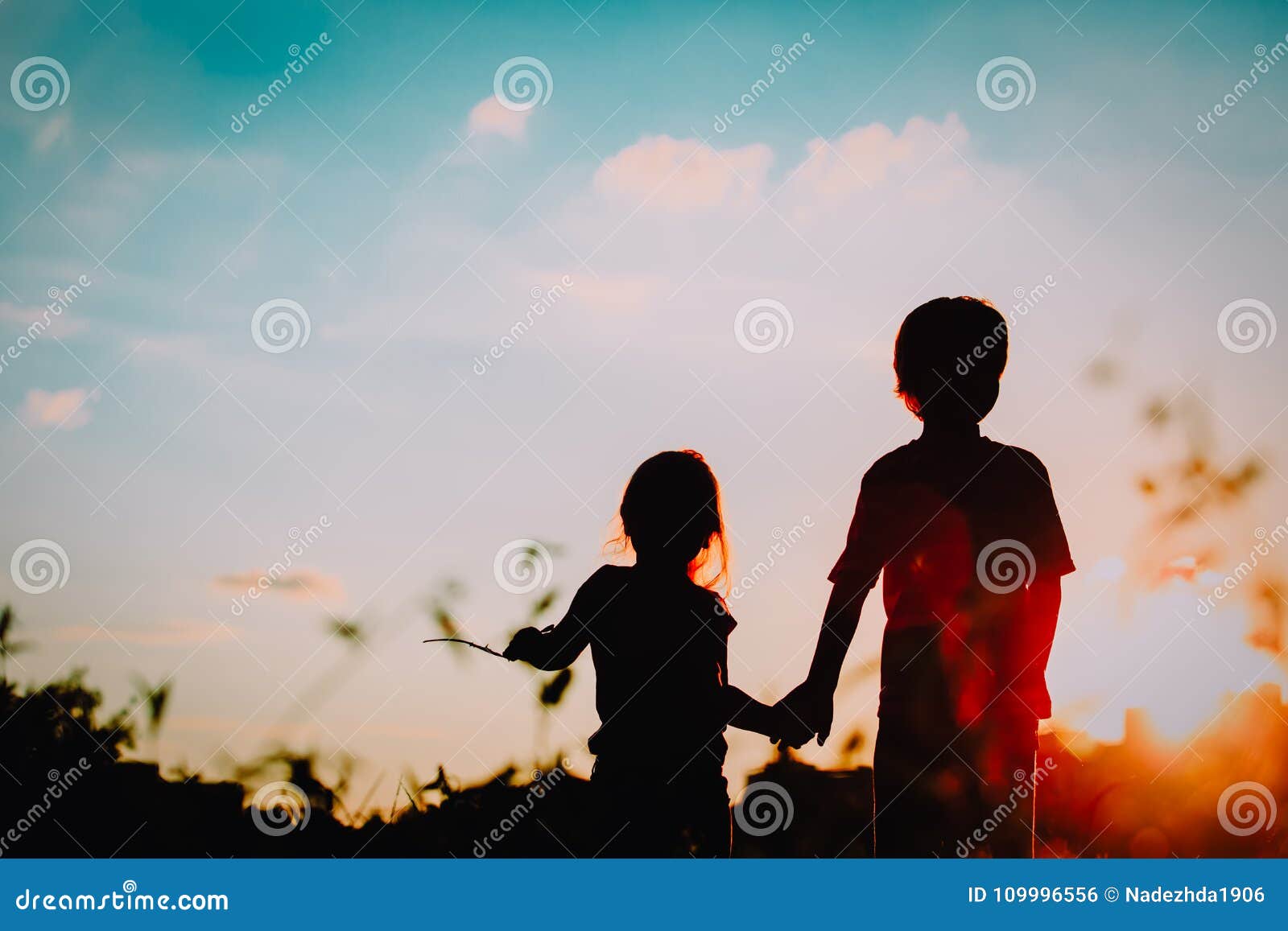 Little Boy and Girl Silhouettes Holding Hands at Sunset Stock ...