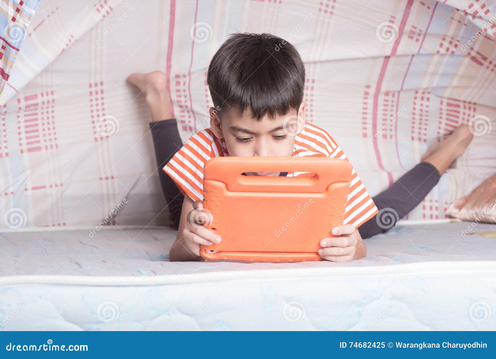 Little Boy Hinding Under Blanket Playing Tablet Game Stock Image