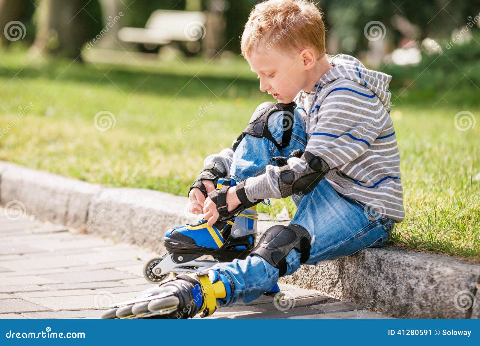 Little Boy Lace His Roller Skate Sitting on the Sidewalk Stock Image Image of healthy, happy