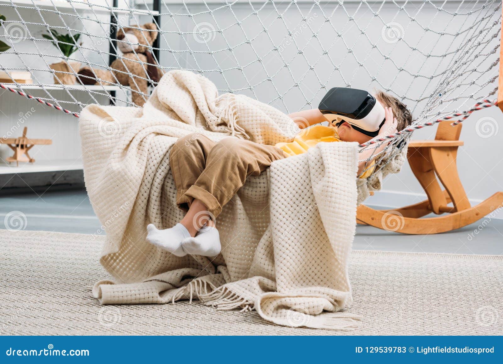 Little Boy Laying in Rope Hammock and Using Virtual Stock Image Image
