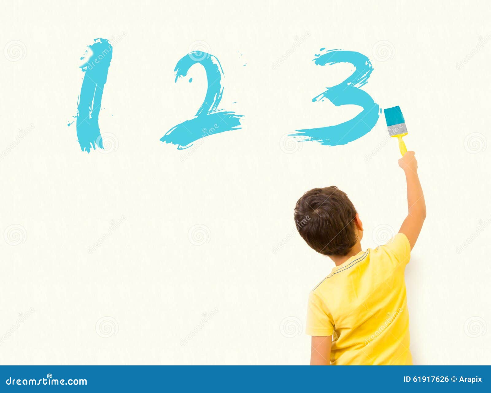 Little Boy Learning Math and Painting Numbers 123 on the Wall Stock