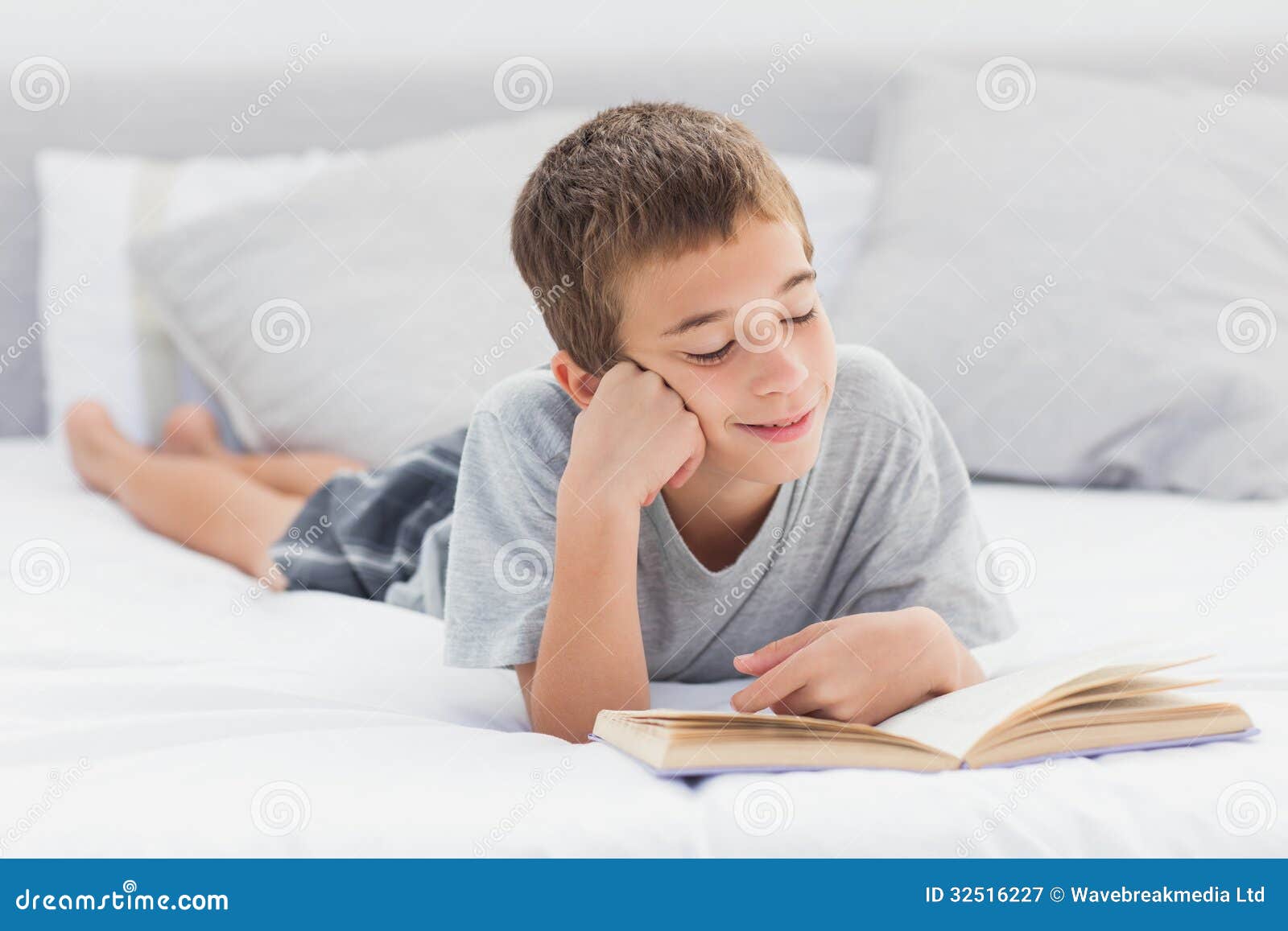 Little Boy Lying on Bed Reading Book Stock Image Image of hair
