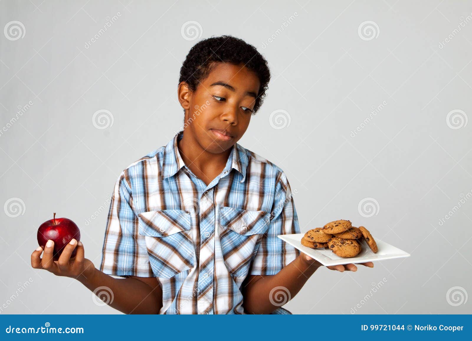 little boy making decisions of eating healthy verses unhealthy.