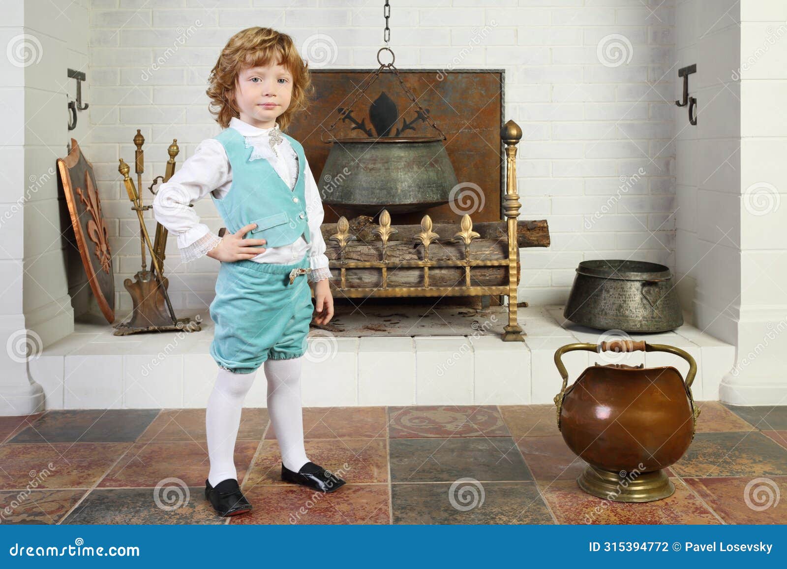 little boy in medieval costume stands near