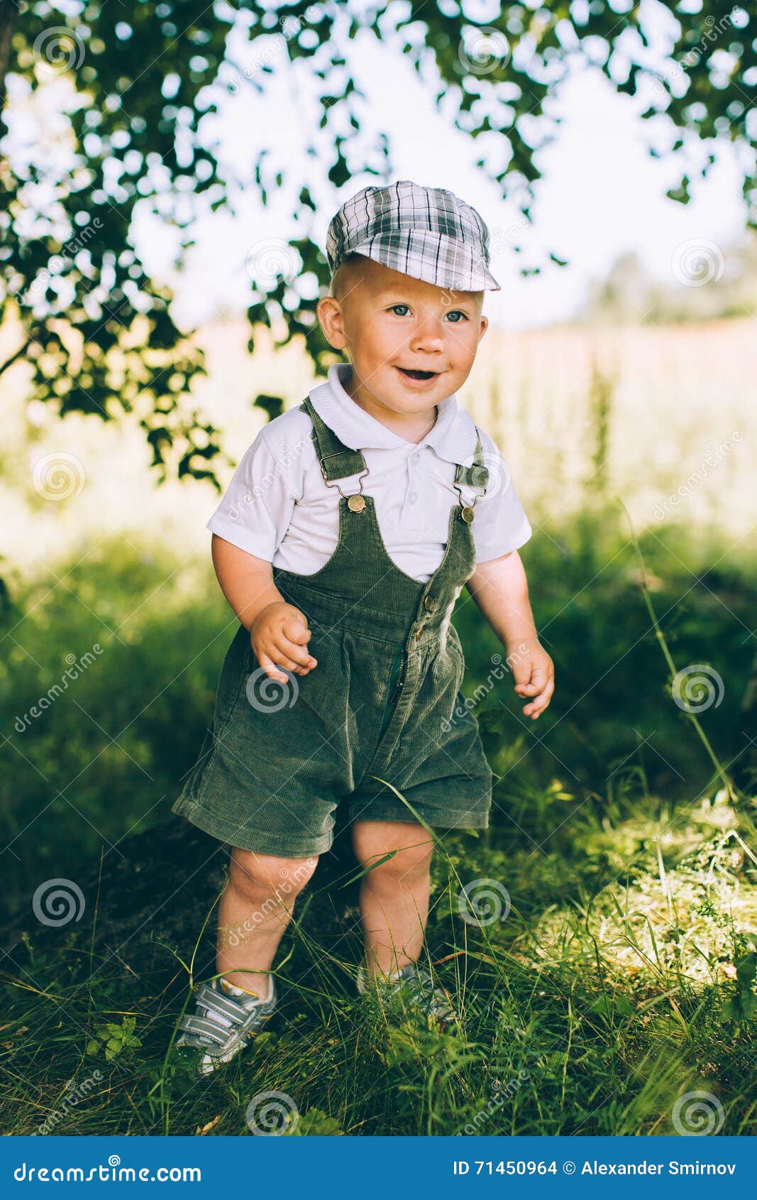 The Little Boy in Overalls and a Cap Stock Photo Image of childhood