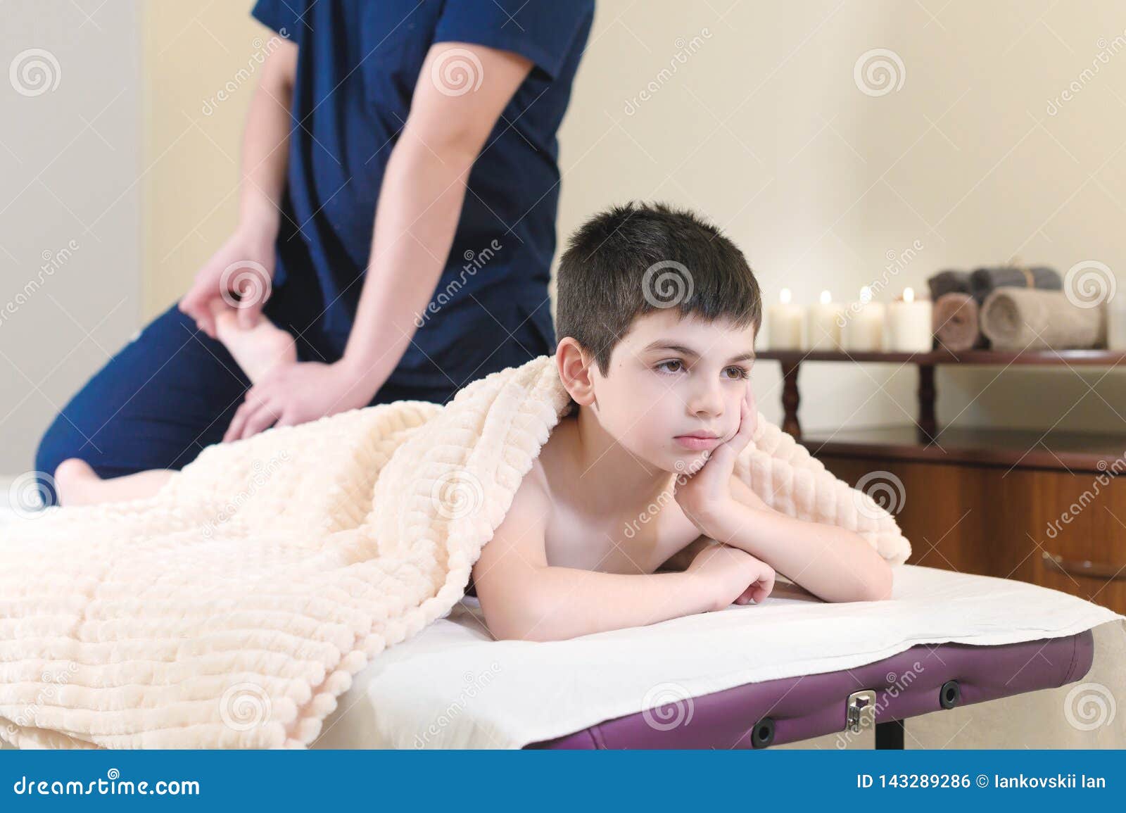 Little Boy Patient At Reception At A Professional Masseuse Foot