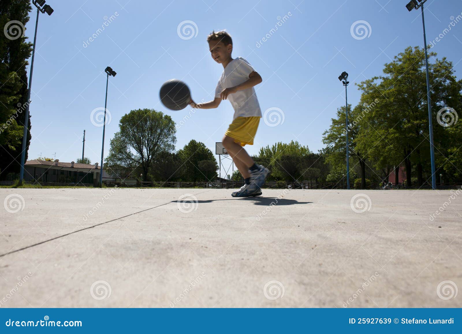 Little Boy Dribbling Basketball Sideview RoyaltyFree Stock Photo